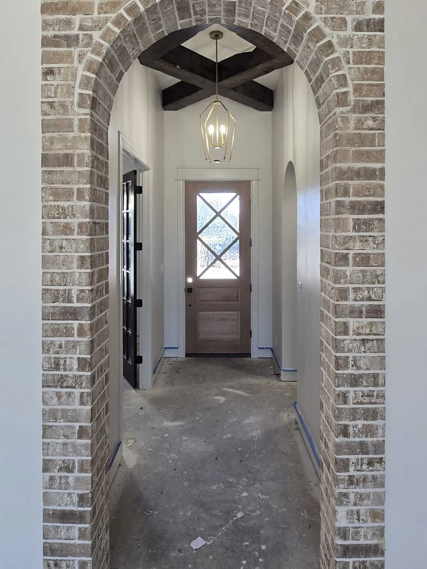 Even under construction, this entryway steals the show. From the timeless brick arch to the ceiling beams and the stunning front door that&rsquo;s awaiting its stain color&hellip;every detail is crafted to make a lasting first impression.

It&rsquo;s