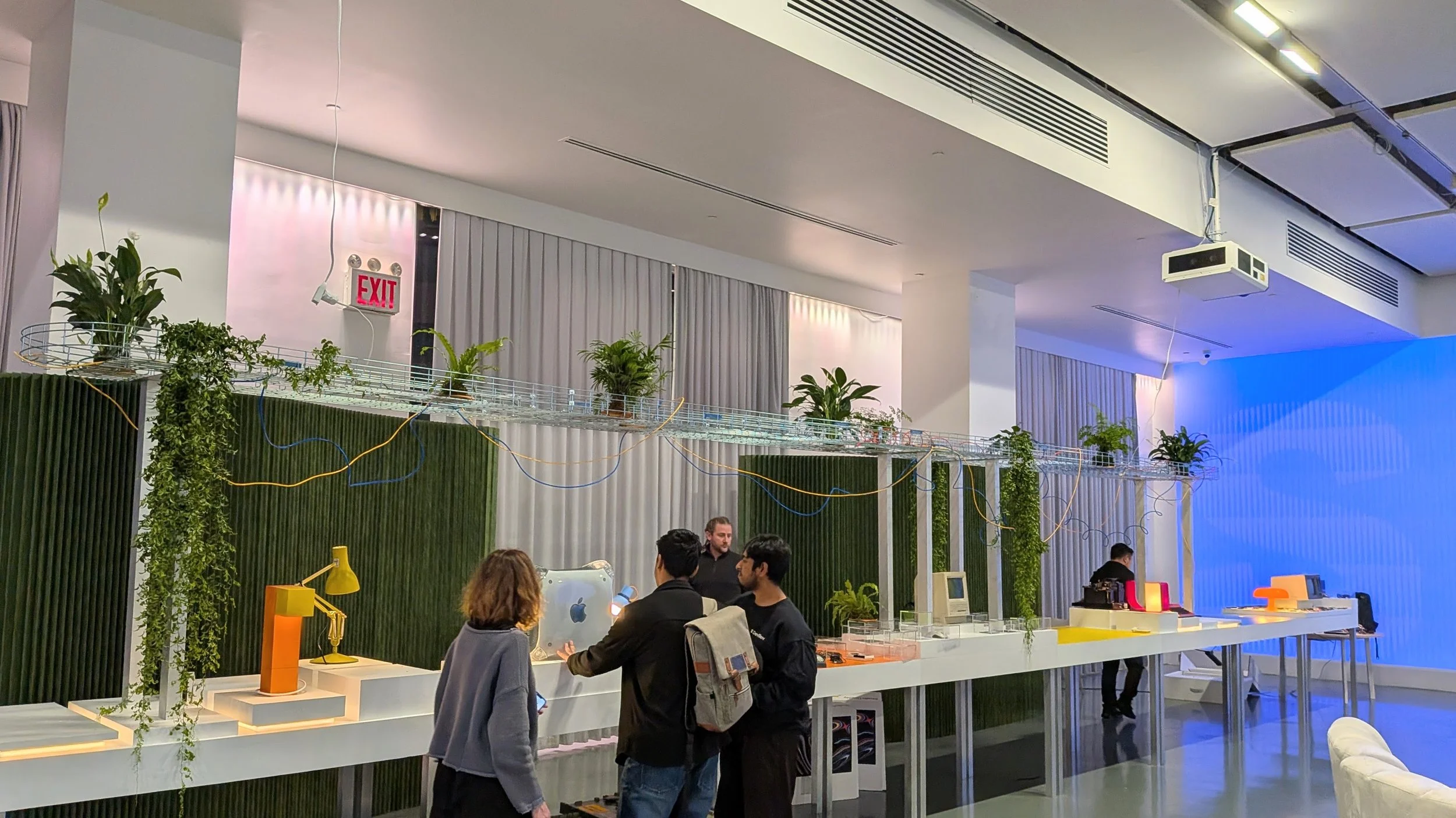 Tech Conference involving plant displays on elevated track above the computer demo area