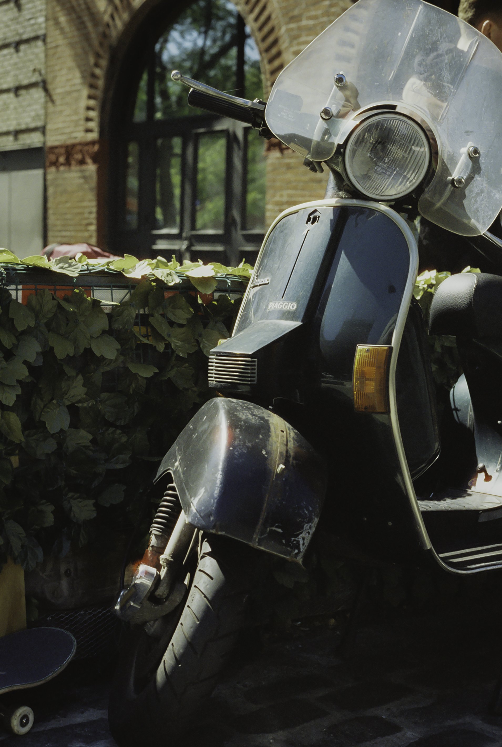 Motorcycle parked by building.JPG