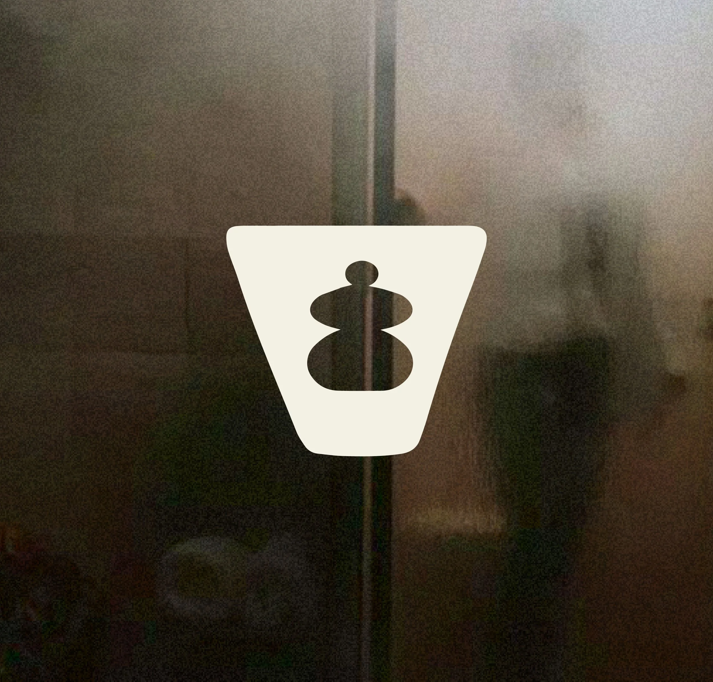 A reflective glass door or panel with a Fuji Xerox logo sticker in the center, showing a silhouette of a person in a dark clothing.
