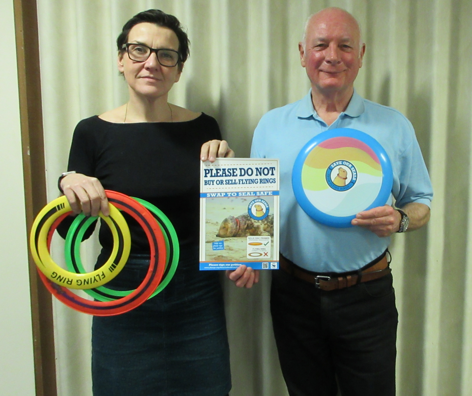 Tonia and Gareth holding flying rings and solid disks.