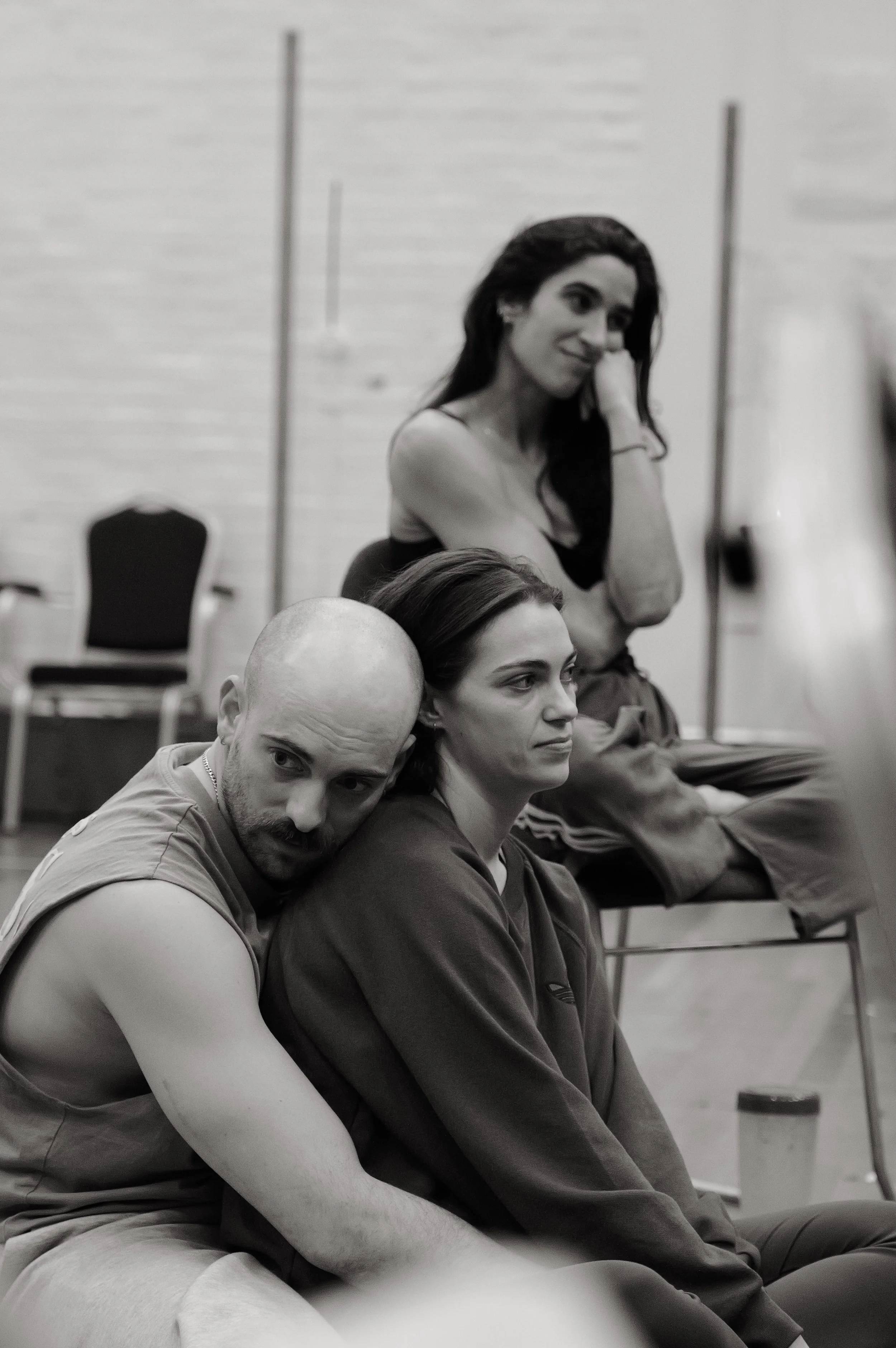 Ali Goldsmith holds Bryony Pennington from behind whilst Lucia Choccaro sits in the background watching the action off camera. photo by Curtis Richard