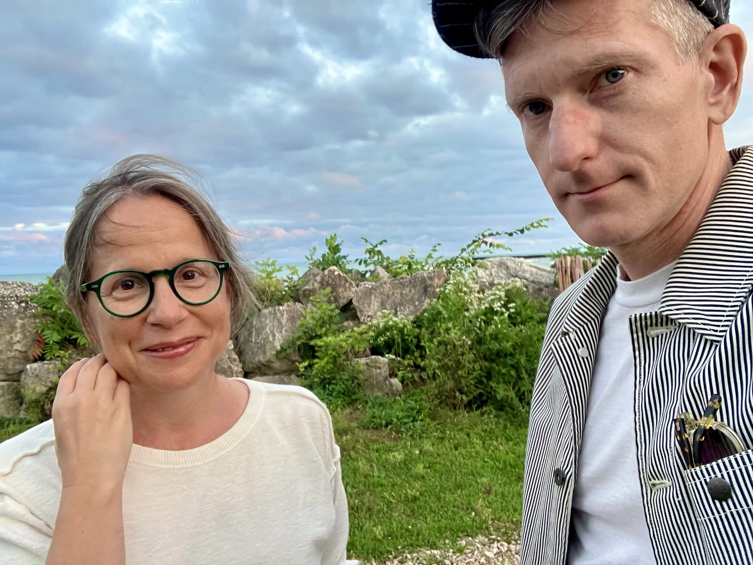 Rebecca Beegle and Robert Melton posing near Lake Michigan in the early evening