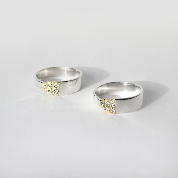 matching pair of silver & 18ct gold rings