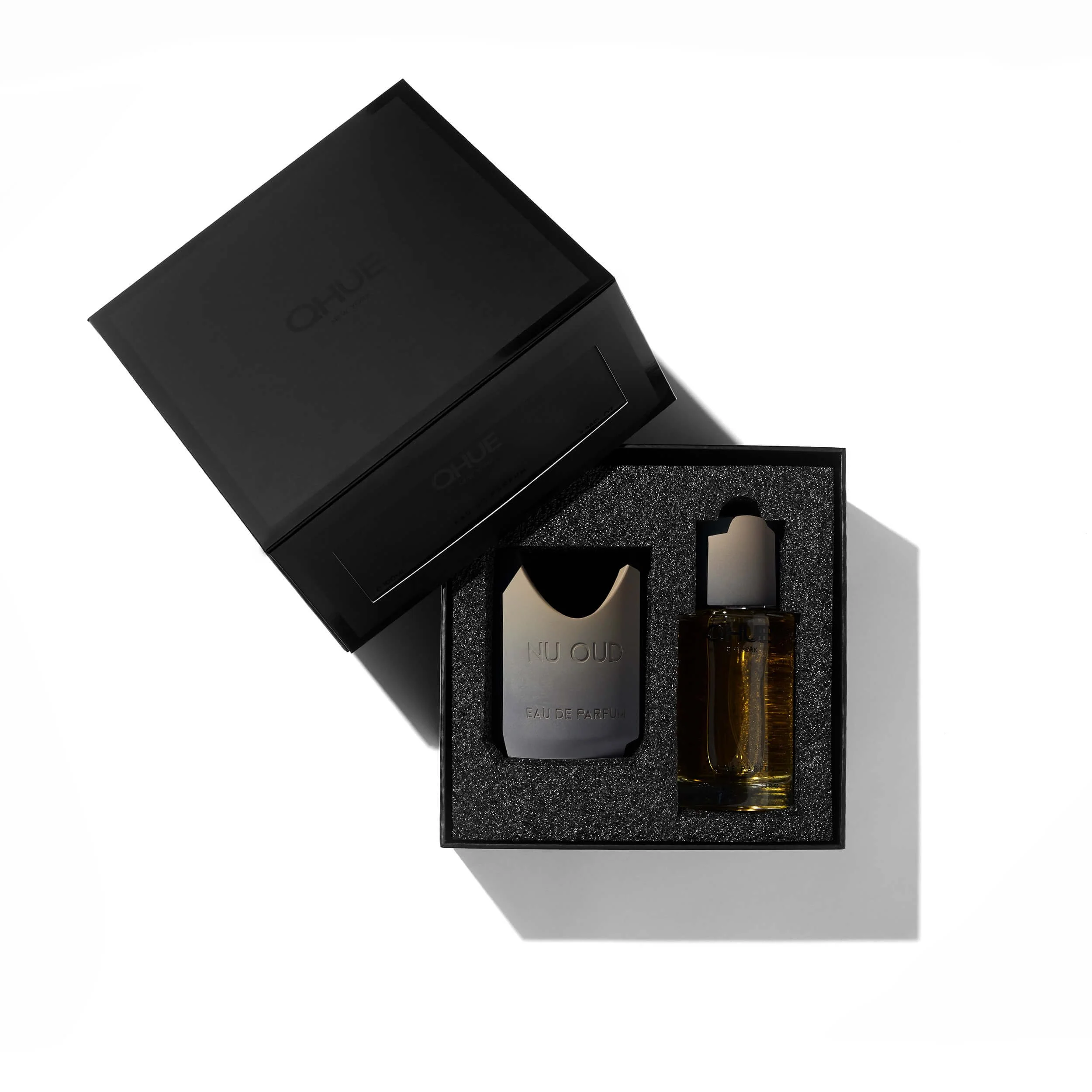 Nu Oud Eau de Parfum and refill vial displayed inside a structured matte-black Qhue New York gift box