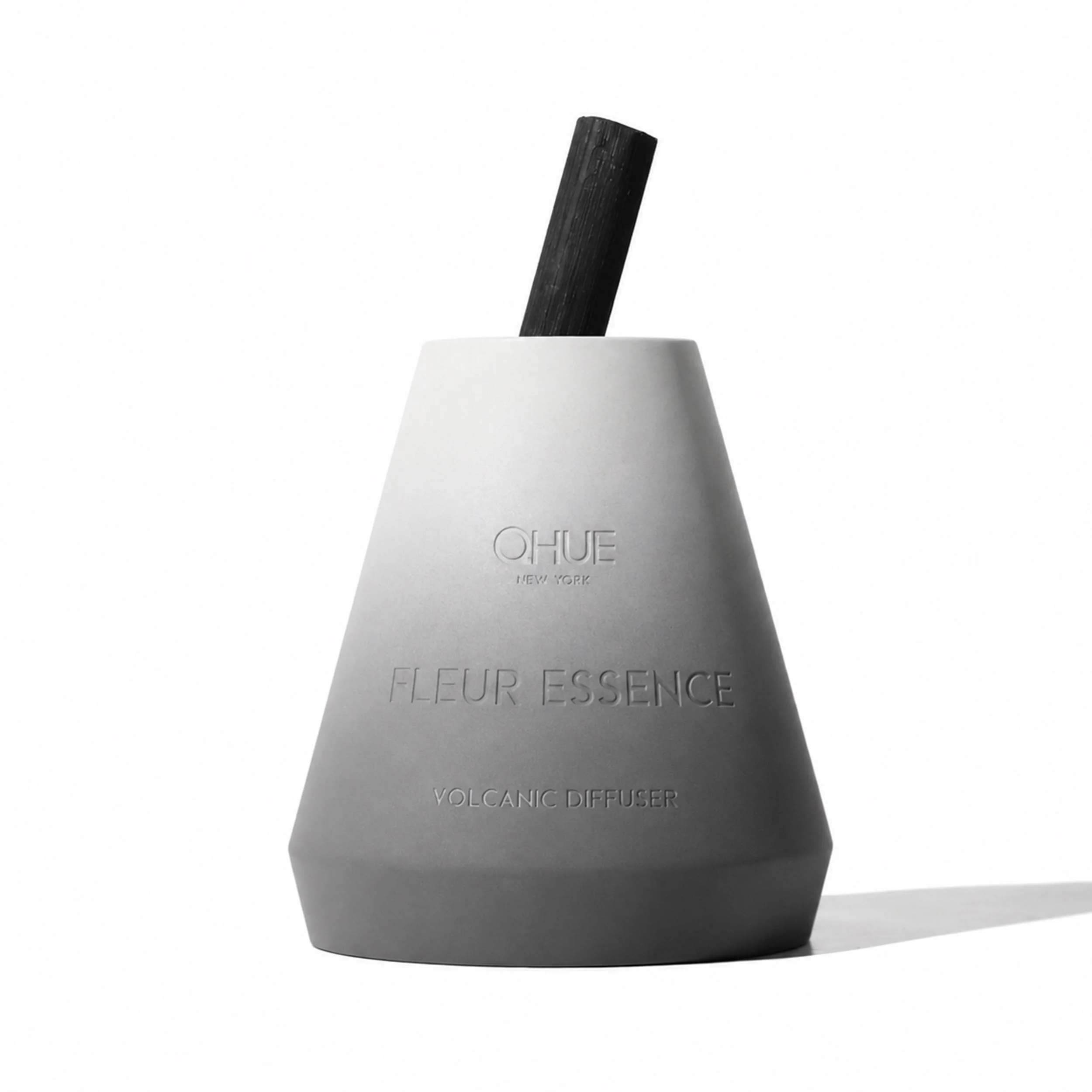 Qhue New York Fleur Essence Volcanic Diffuser in a hand-painted cement vessel with a natural bamboo reed for continuous home fragrance.