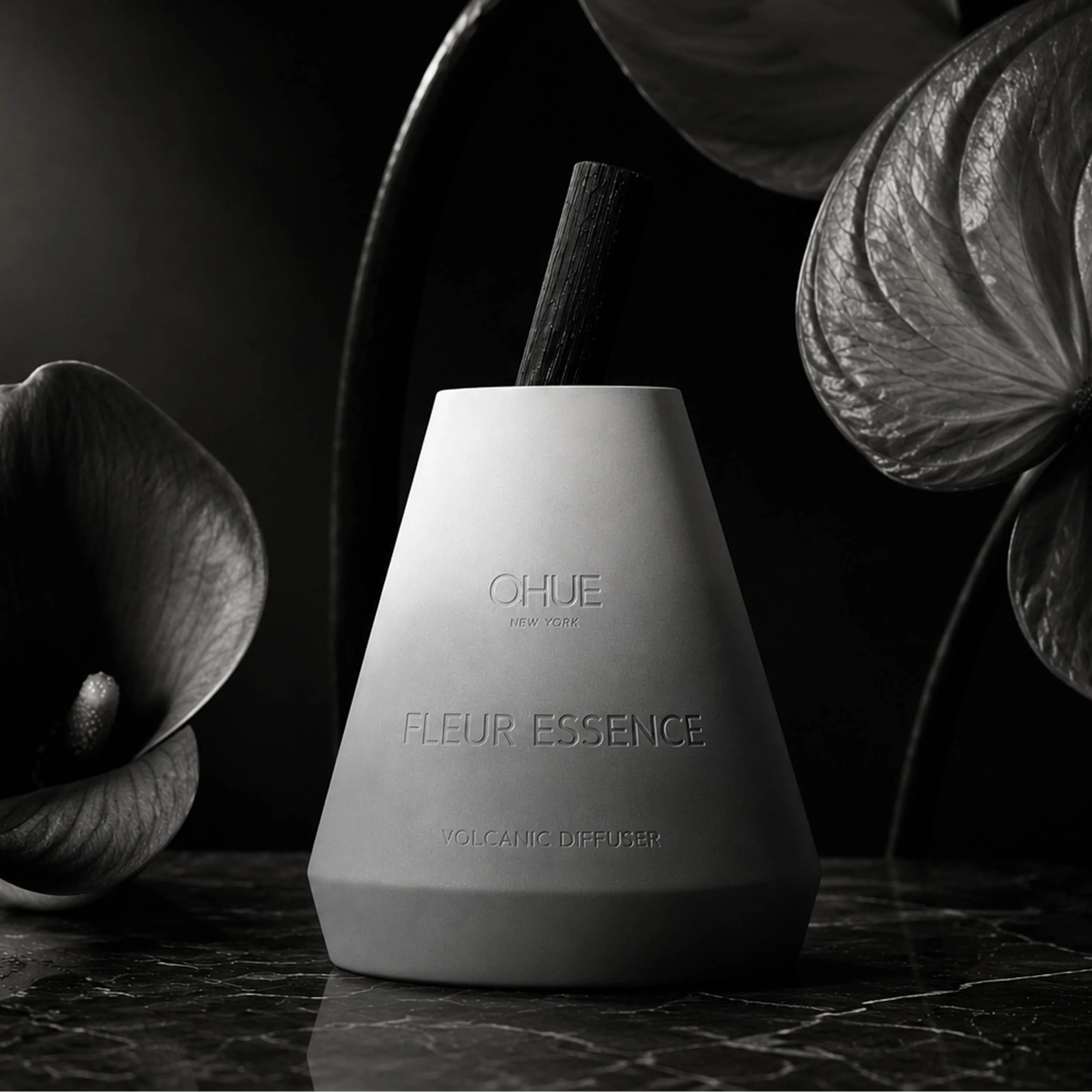 Qhue New York Fleur Essence Volcanic Diffuser in a hand-painted cement vessel with elegant floral-inspired styling and a natural bamboo reed.