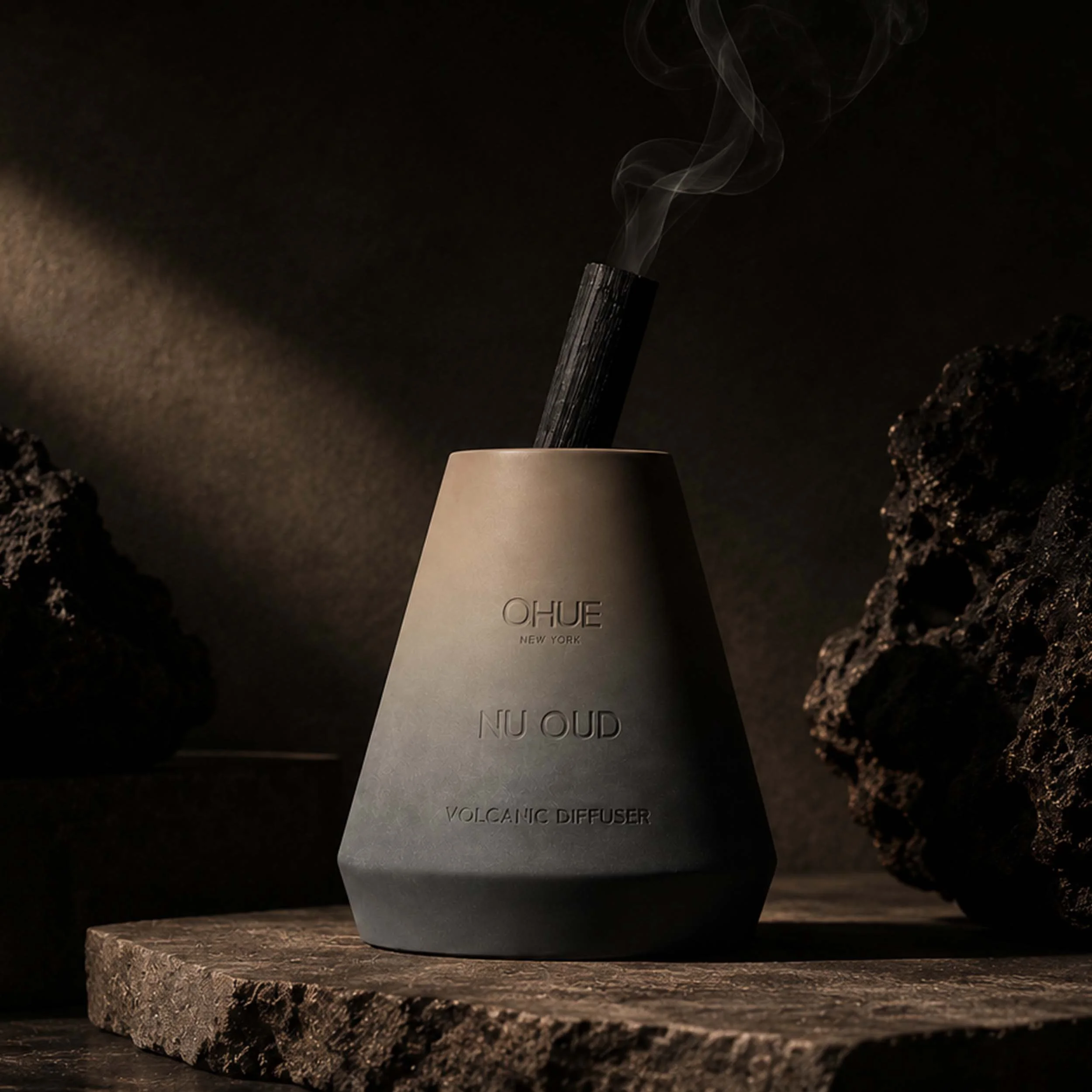 Qhue New York Nu Oud Volcanic Diffuser in a hand-painted cement vessel inspired by oud wood, warm amber, and smoky woods.
