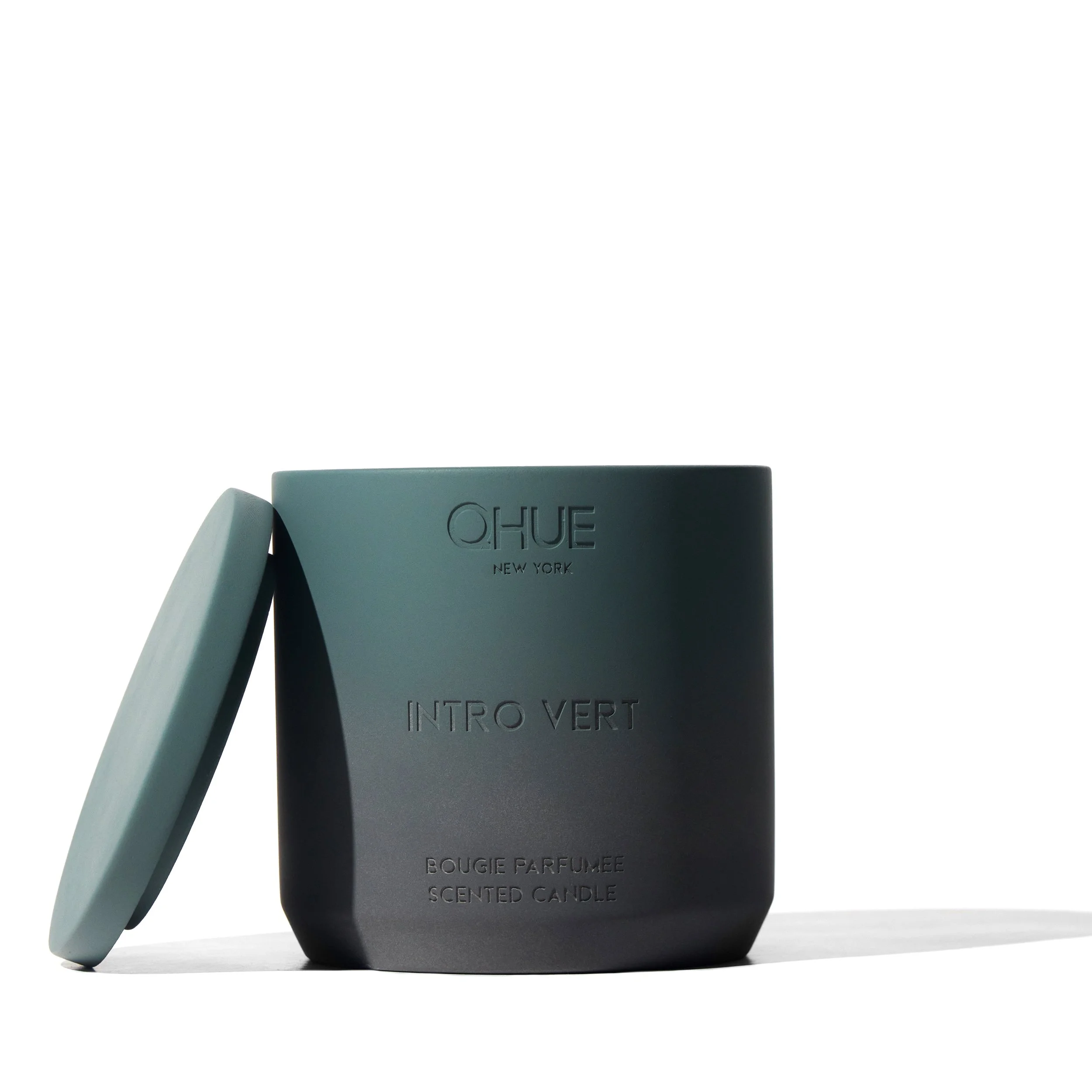 Intro vert candle in a ombre cement vessel engraved with the Qhue New york logo