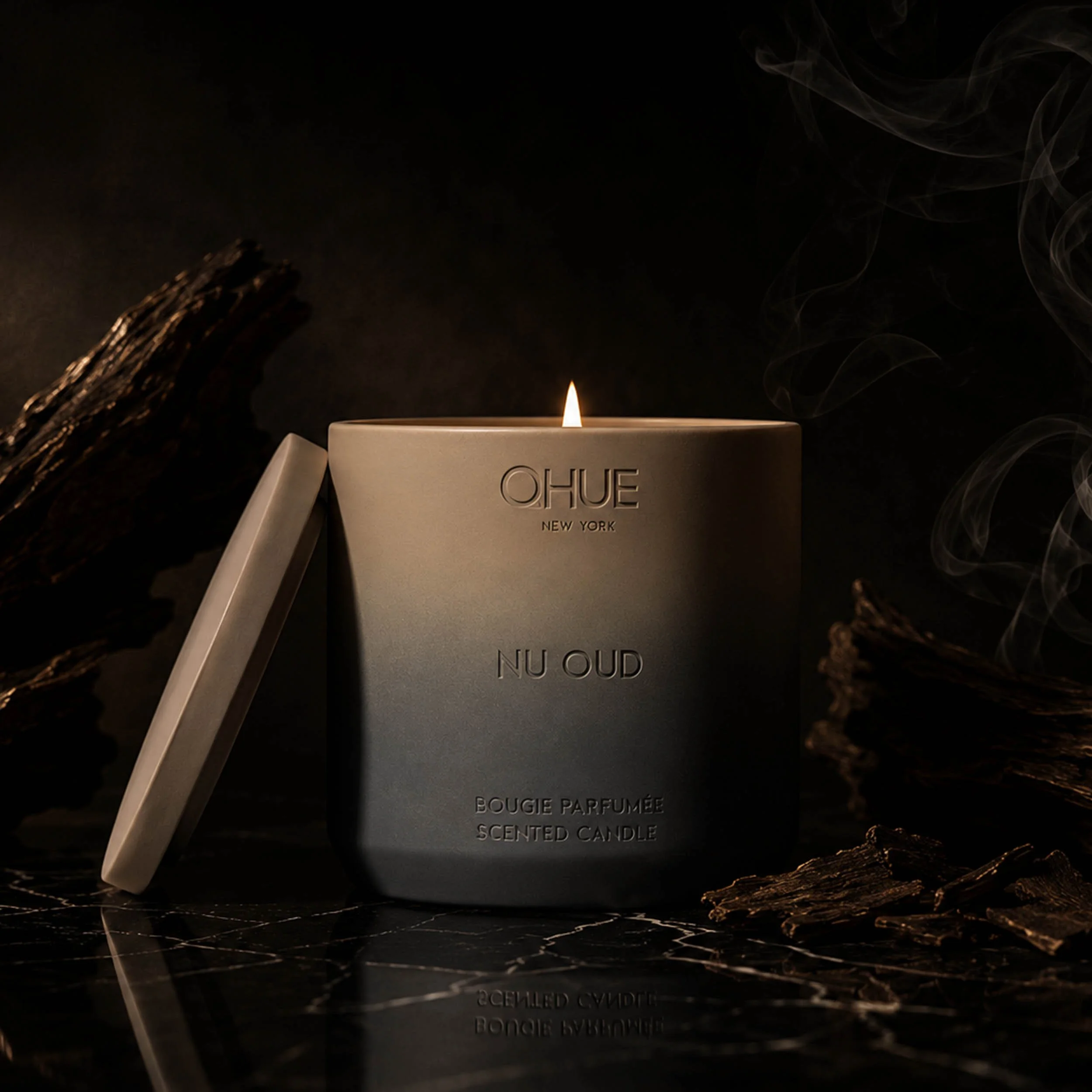 Qhue New York Nu Oud luxury scented candle in a hand-painted cement vessel inspired by oud wood, warm amber, and smoky woods.