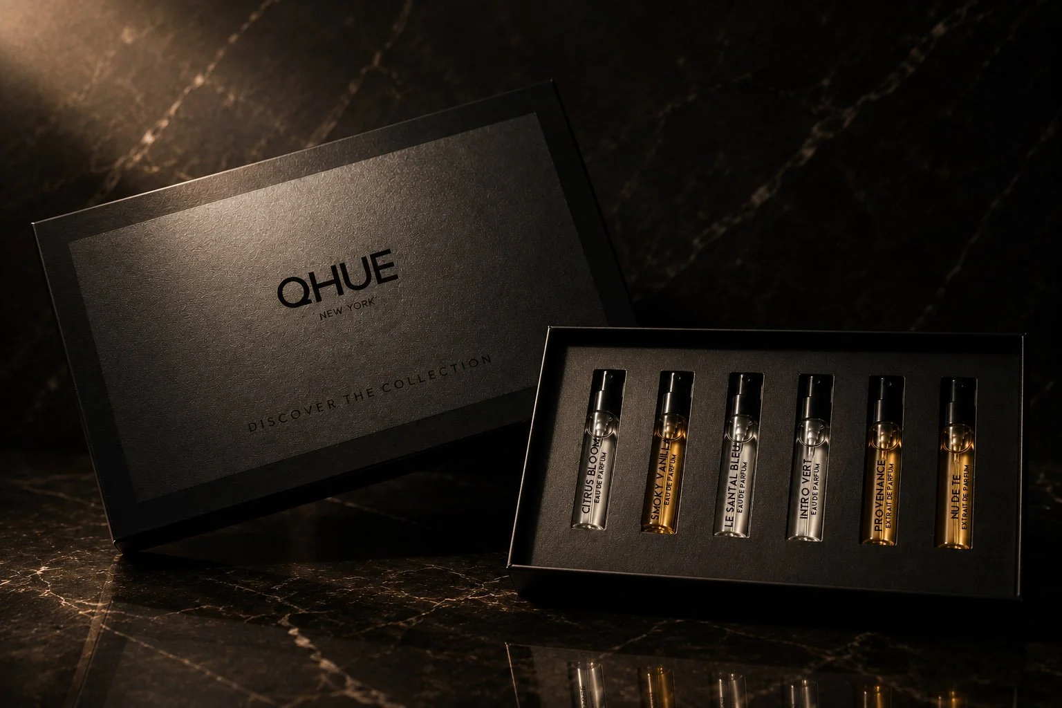 Qhue New York customized luxury fragrance discovery kit with six perfume samples in a premium black presentation box.