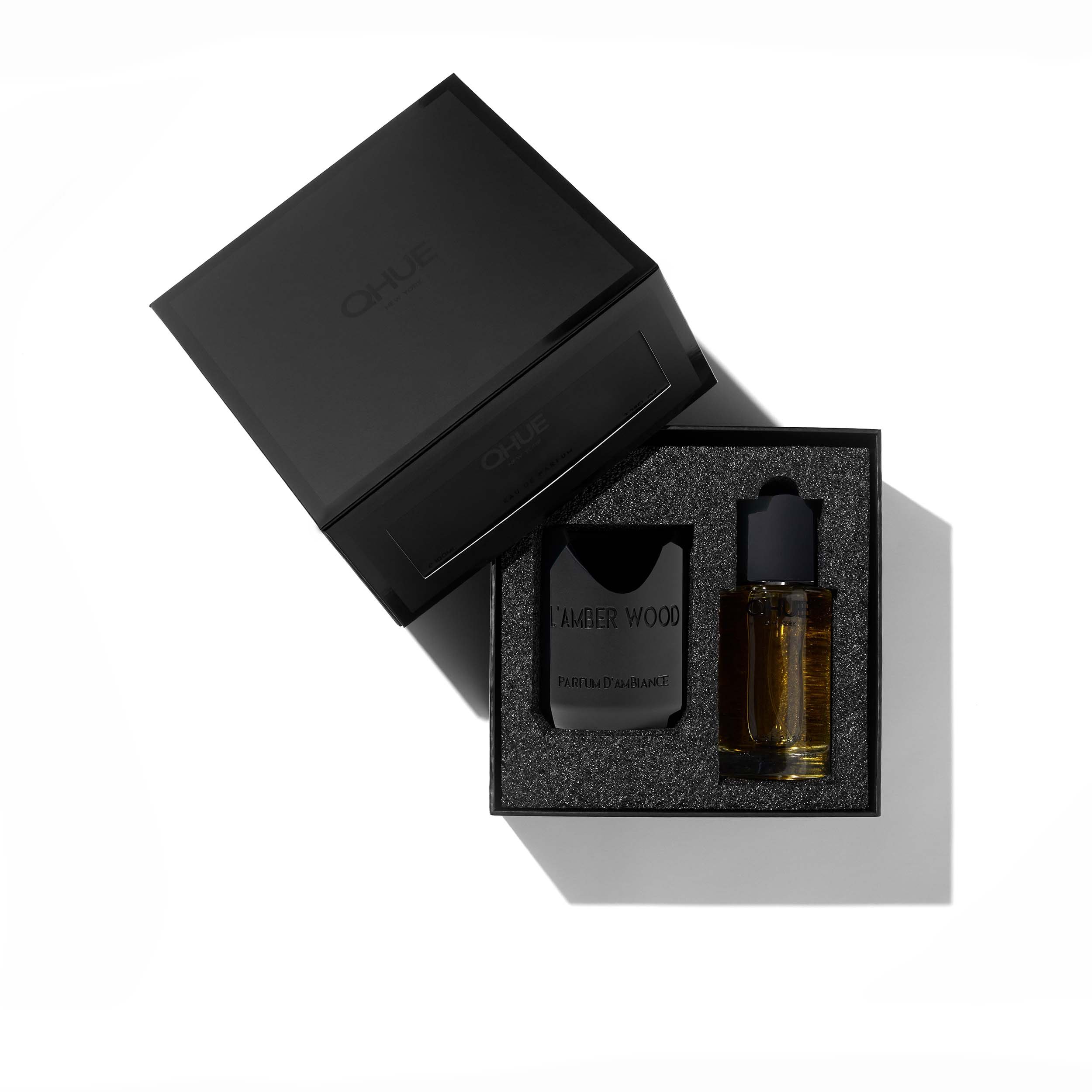 Qhue New York L’Amber Wood Eau de Parfum in a matte black box.