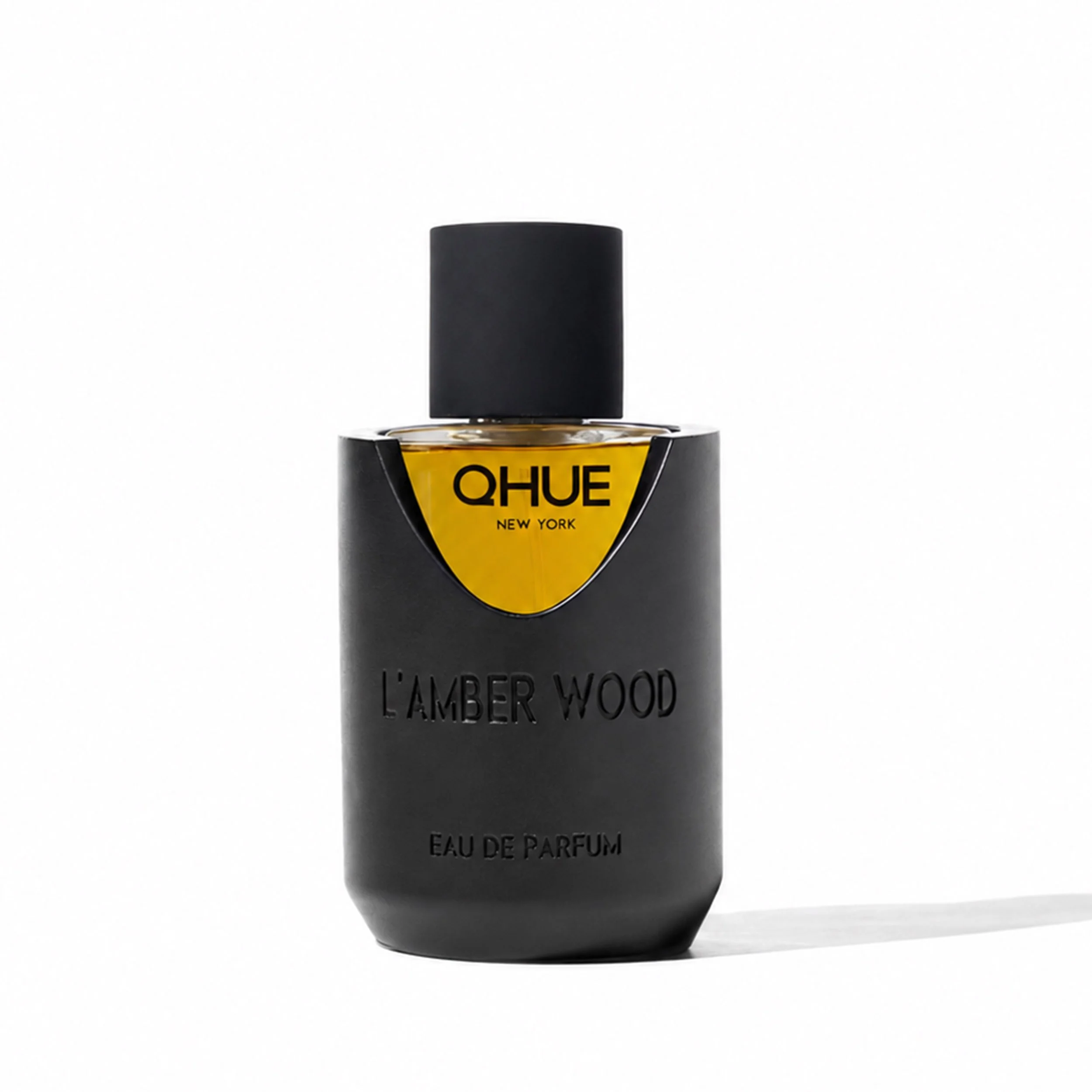 Qhue New York L’Amber Wood Eau de Parfum in a matte black vessel.