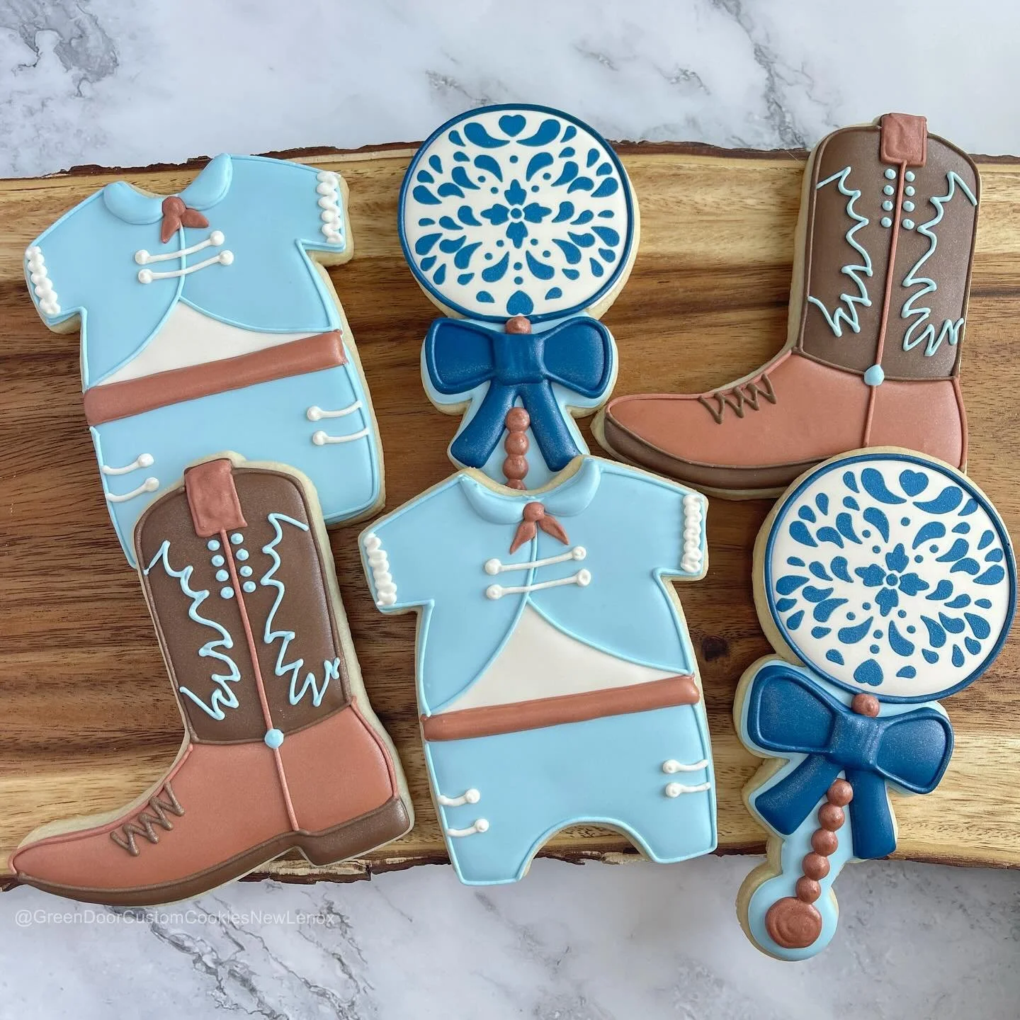 Another fun baby shower order! 😊 👢 🩵 

Making a stencil for the top of the rattle definitely saved me a lot of time and I love how they look.

#Greendoorbakerynewlenox #newlenox #newlenoxil #newlenoxillinois #illinois #instacookies #customcookies 