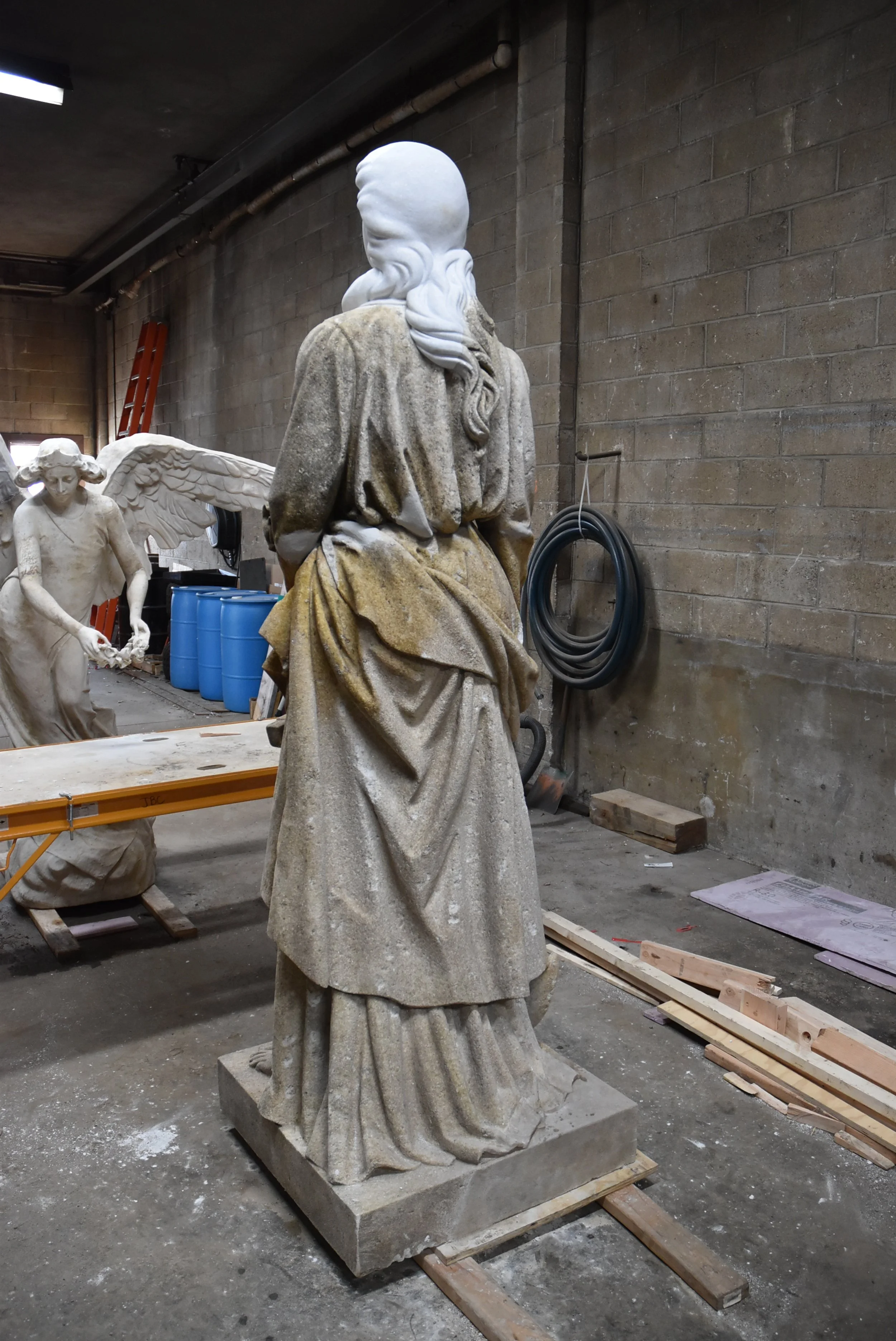 A sculpture undergoes treatment after being broken into several pieces.