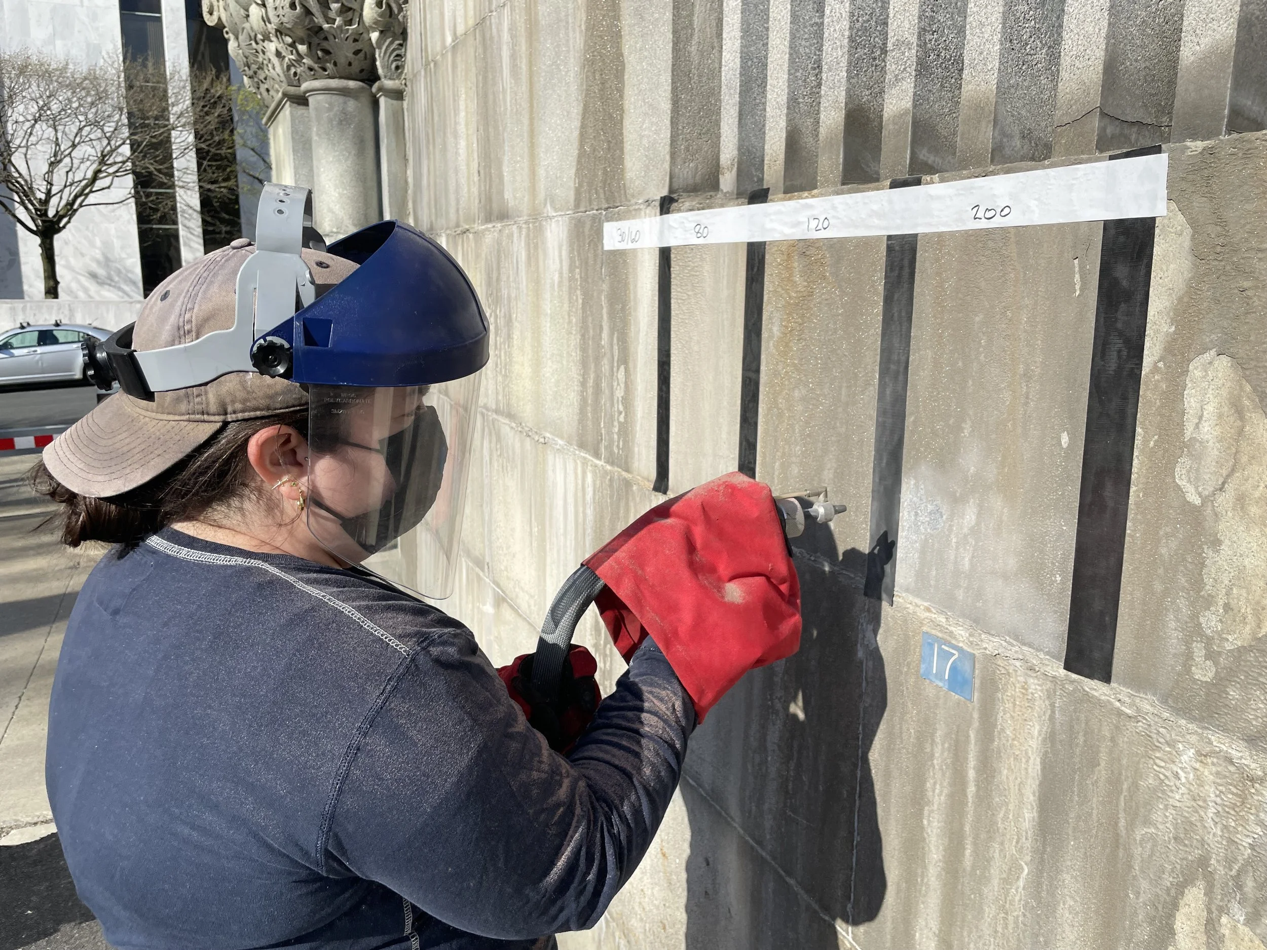 Testing micro abrasive cleaning to remove heavy deposits on granite.