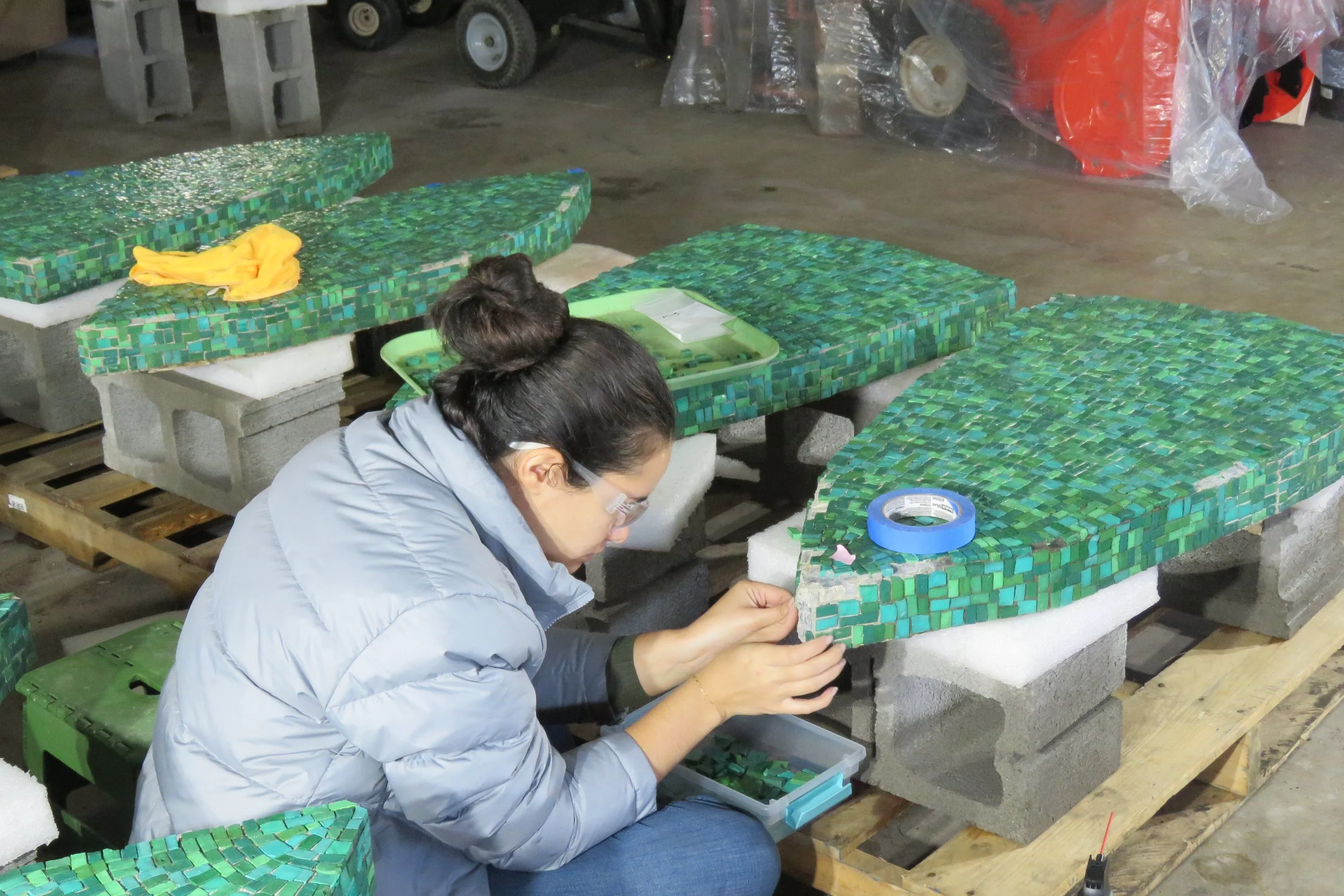 A conservator replaces missing mosaic tesserae.