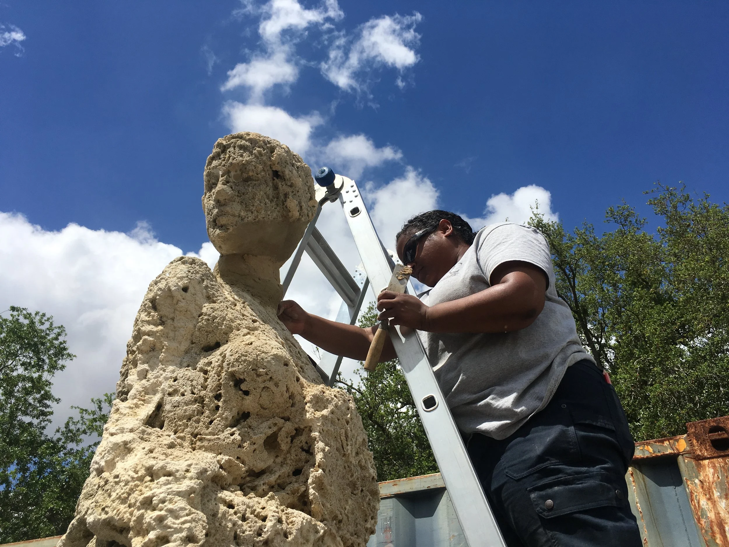 Patching a sculpture.