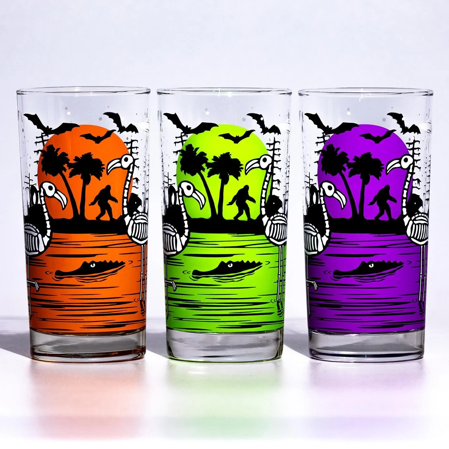 Now in the shop! Our popular Eerie Everglades Halloween Drinkware, back in Rocks and new UV Fluorescent Paranormal Purple &amp; Swampland Slime in the Collins. These glasses feature a Florida swamp scene with glow-in-the-dark skeleton flamingos, a UF