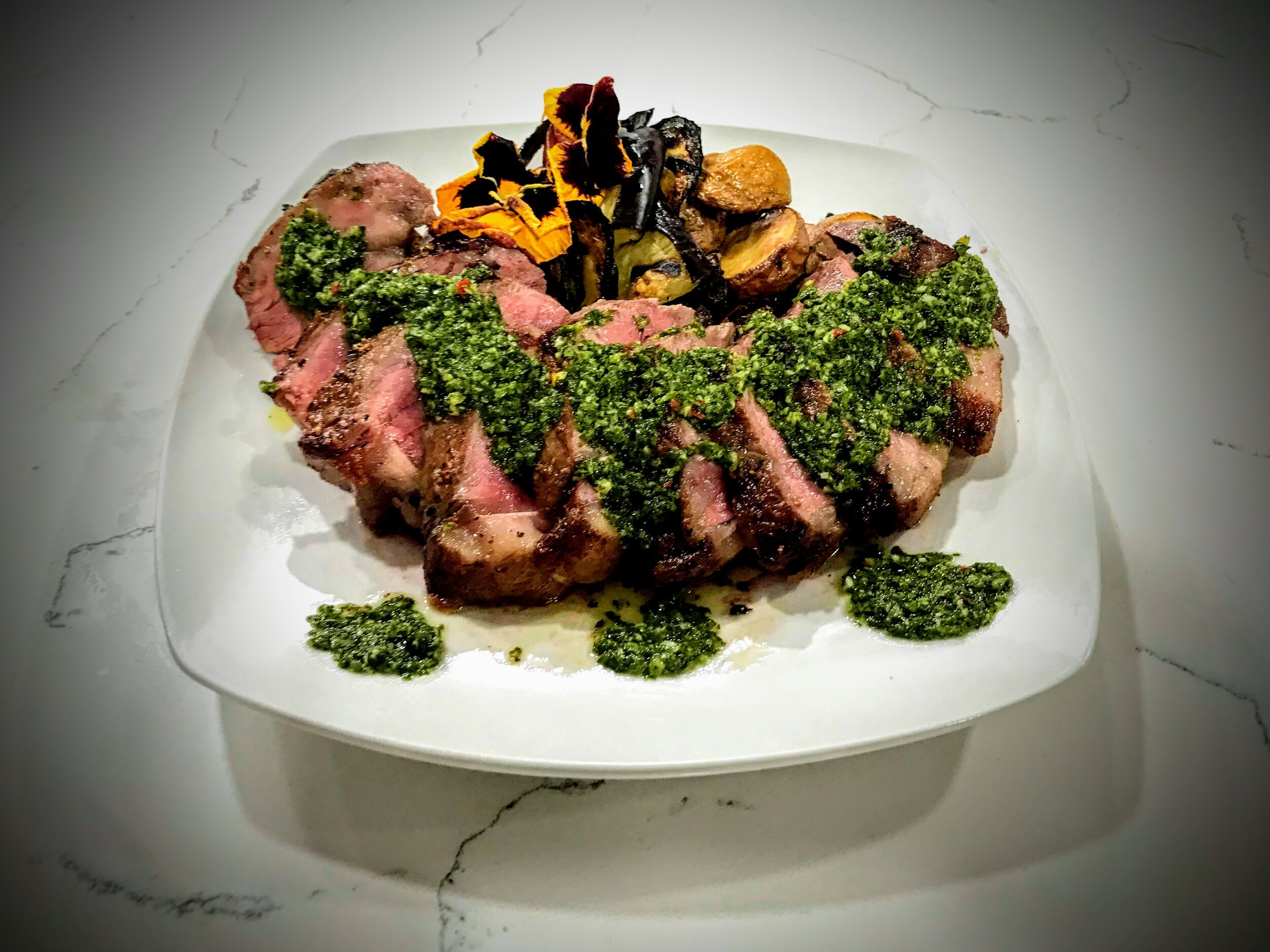 Chimichurri rib-eye, roasted potatoes, and grilled summer squash