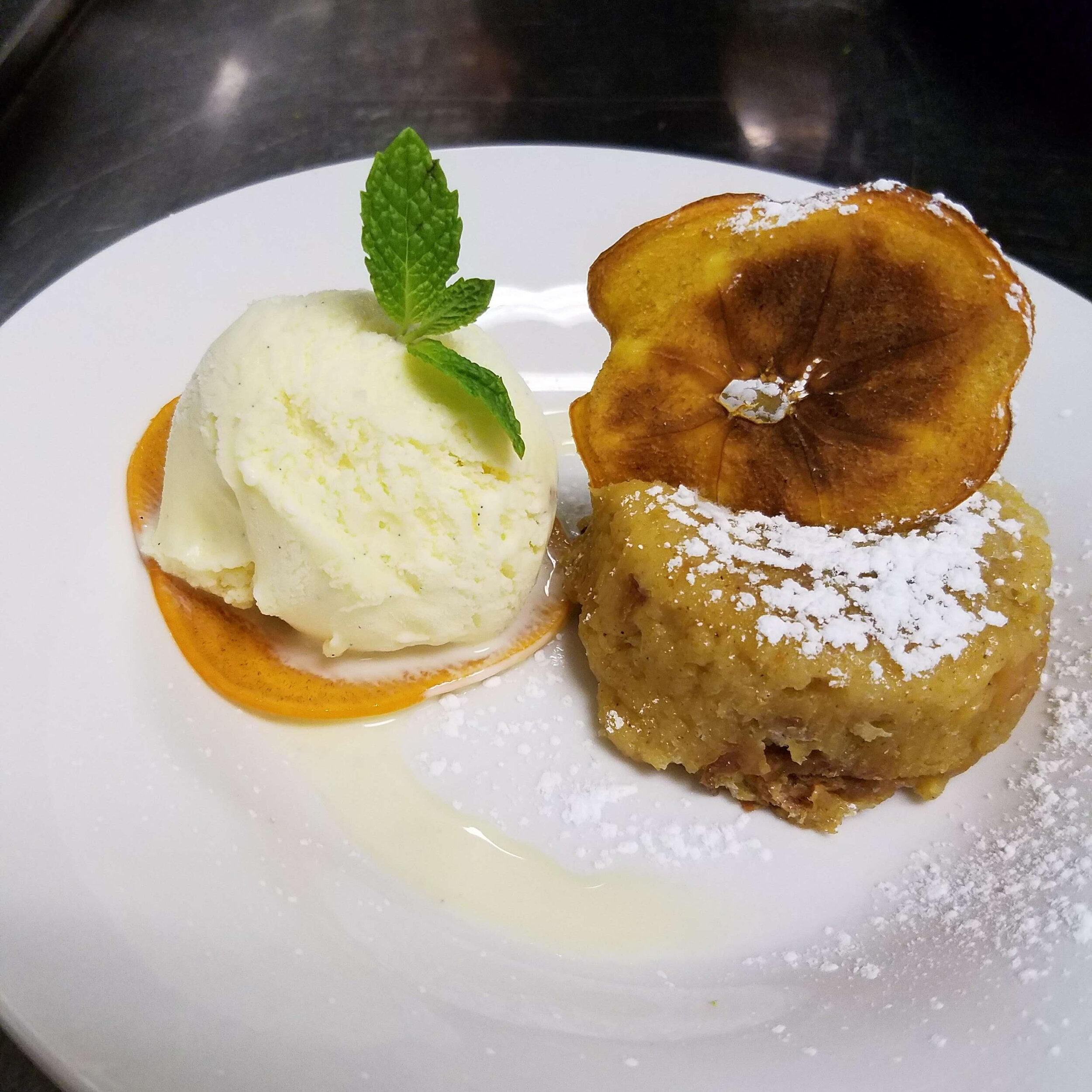 Scorched persimmon and cinnamon bread pudding with vanilla ice-cream
