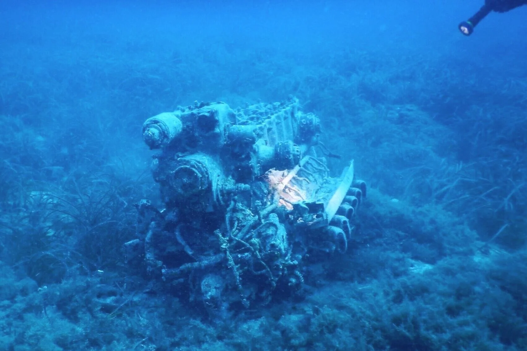 Scuba diving large motor  block in ocean