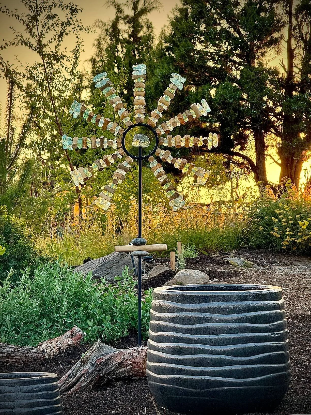  Second Prize &middot; 2026  Doug Hillman  Doug Hillman chose one of our glass, stone &amp; wood sunburst stands to create an icy-cool contrast against the late afternoon sunlight. The two matte black wave pots in the forefront are a nice touch! Than