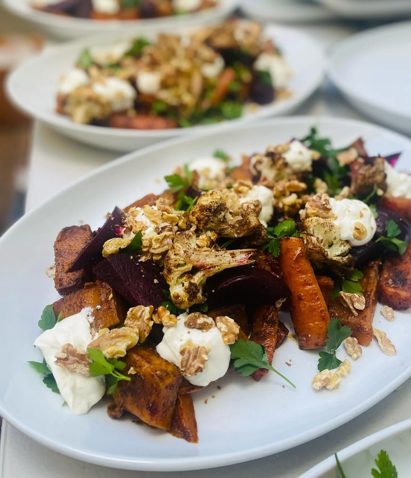 Catering days. Middle eastern inspired roasted root veg salad with tahini yoghurt, some sumac for a bit of tanginess and lots of fresh herbs.