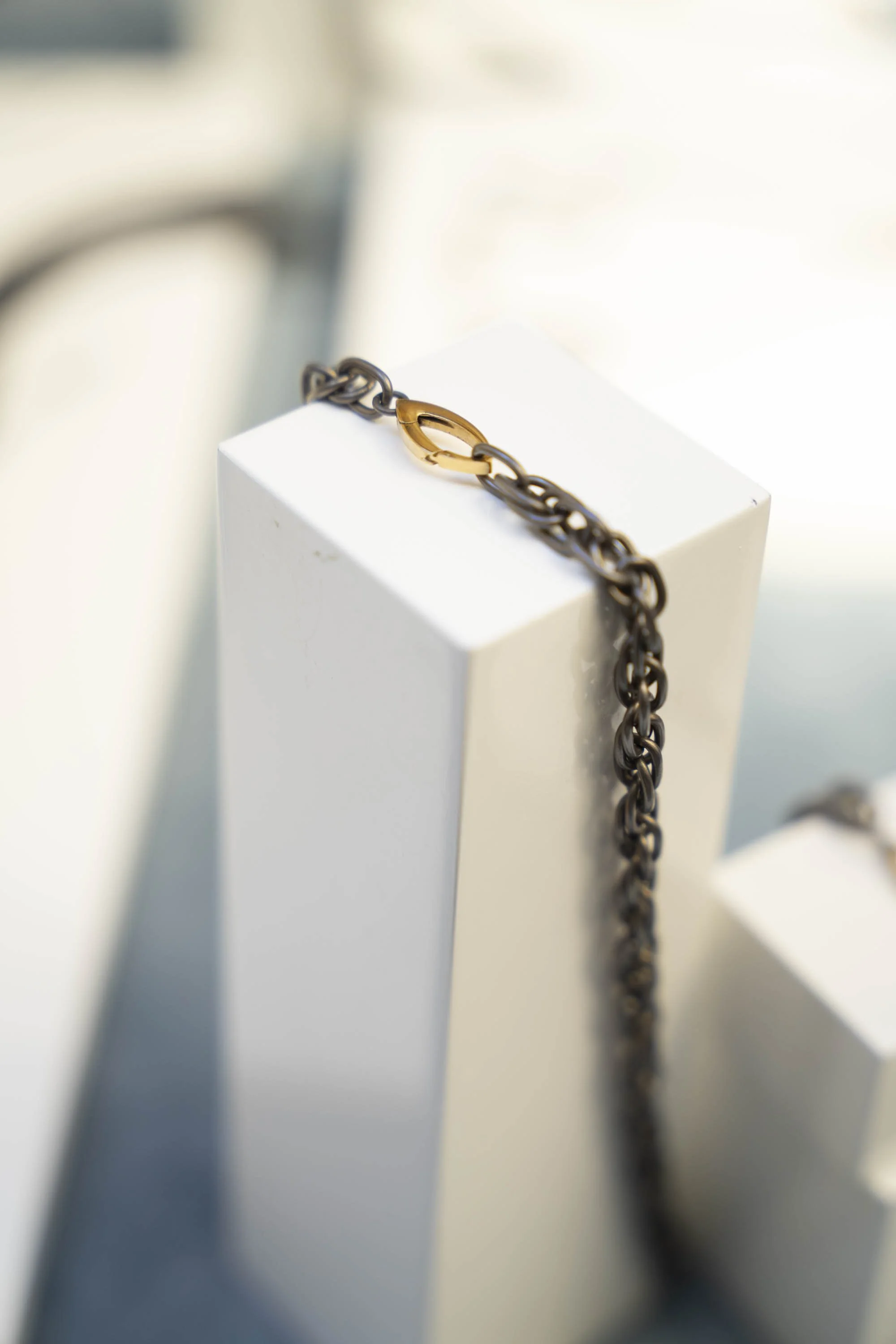 Close-up of the titanium chain and gold-plate marquis clasp on the Twine Necklace