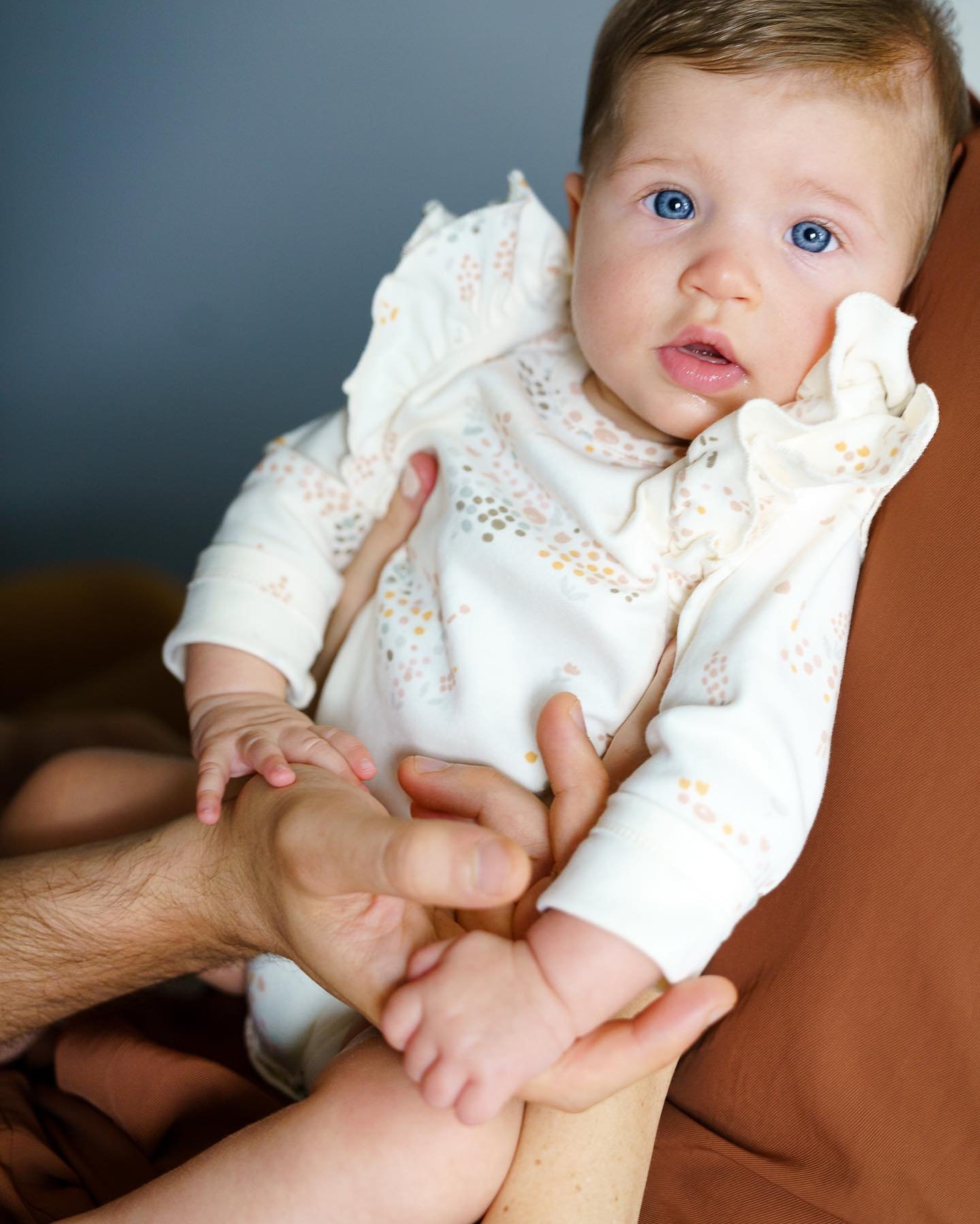 I&rsquo;m not sure what I love more about this - those baby blues or the way her hands are melt into mom and dads.