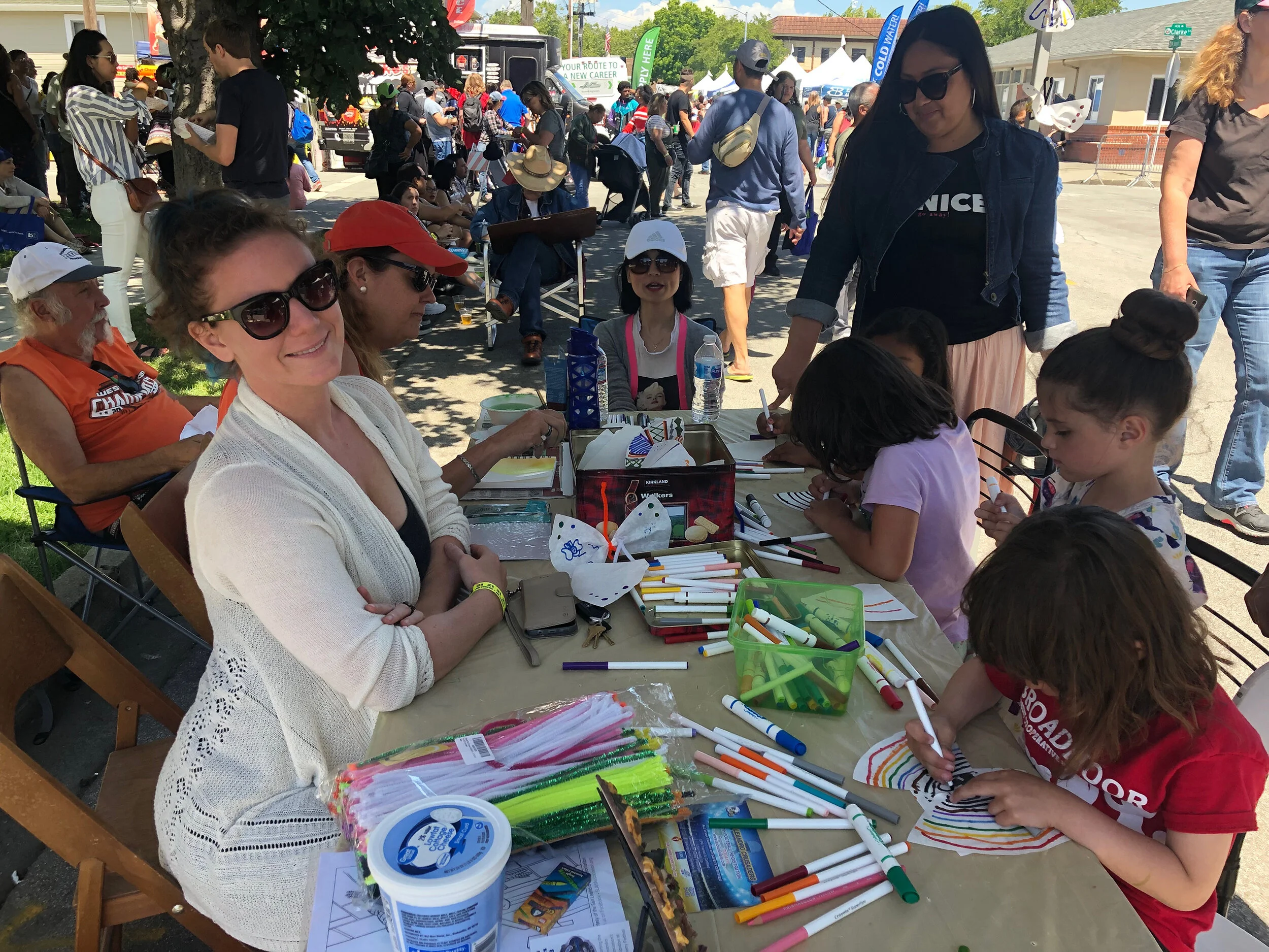 Volunteers helping children make art