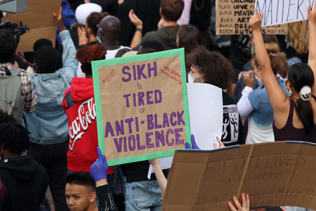 Man holding sign supporting black community