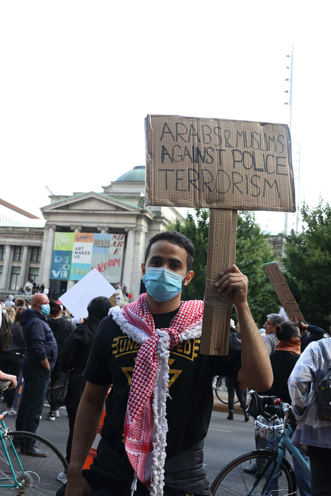 Man holding sign supporting black community