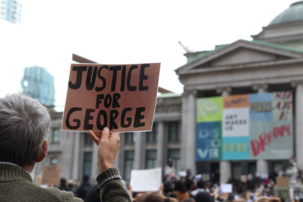 Man holding Justice For George sign