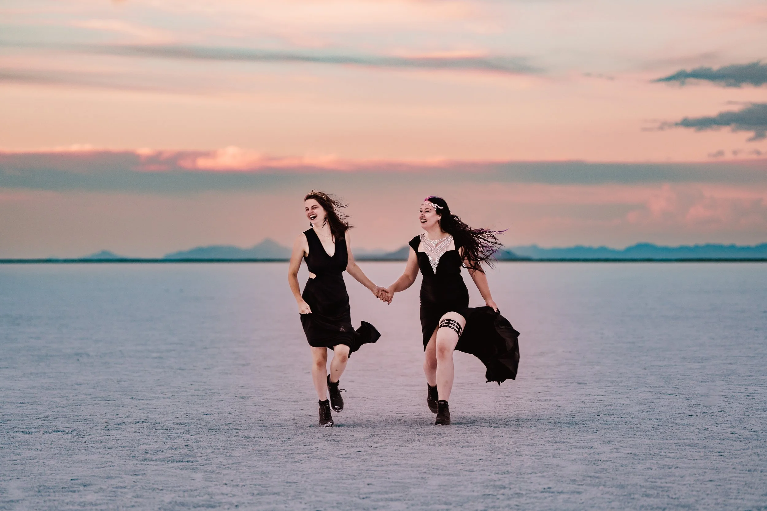 LGBT couple running across salt falts