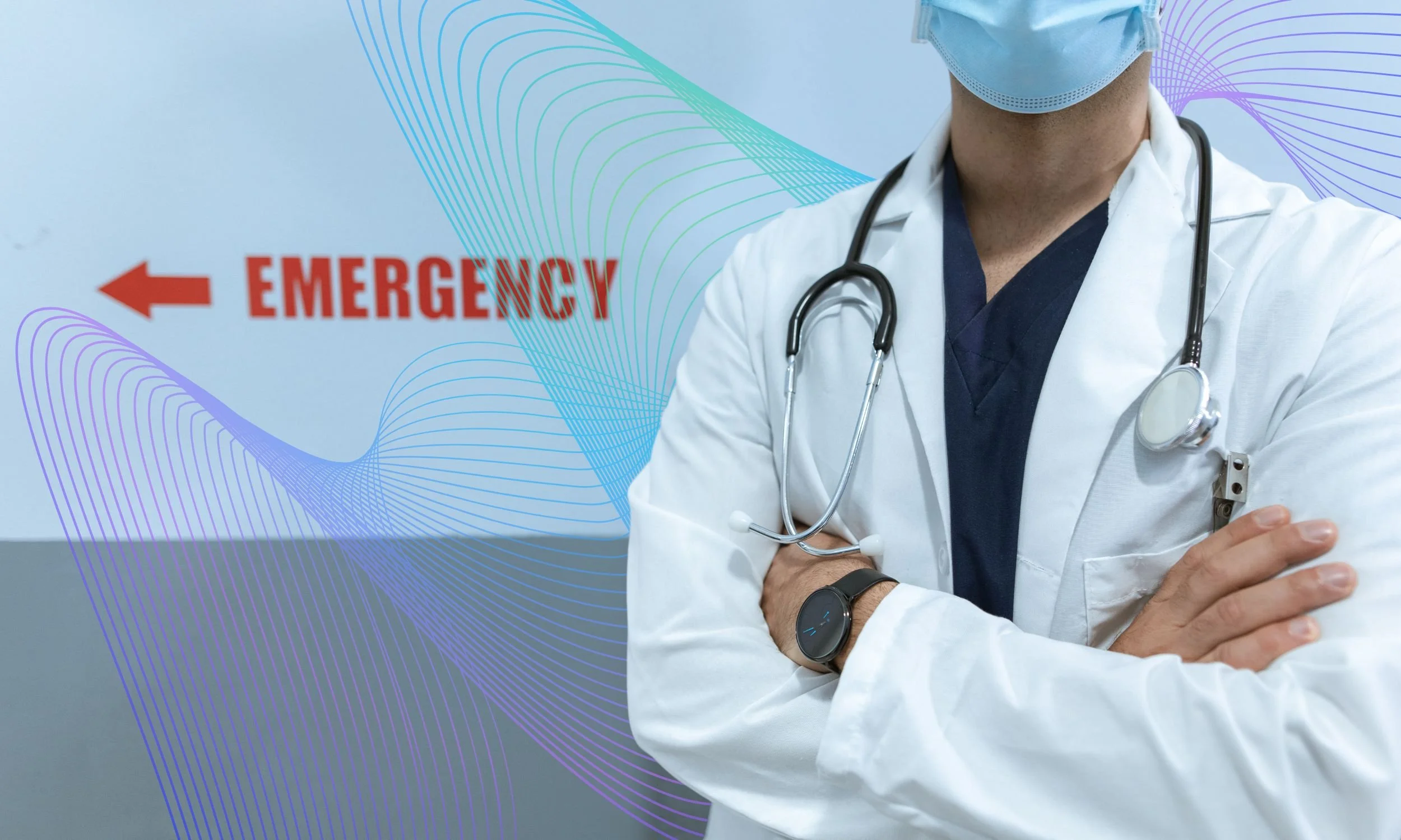 person in white coat, standing in front of a sign pointing to where the emergency room is