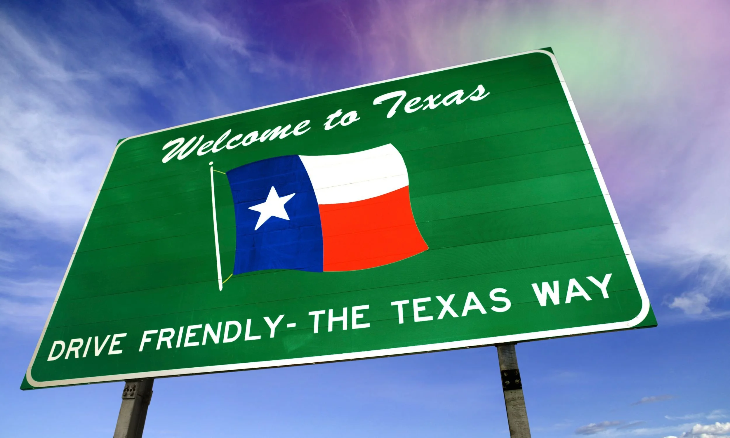 A green highway sign reads "Welcome to Texas" with the Texas flag and "Drive Friendly - The Texas Way".