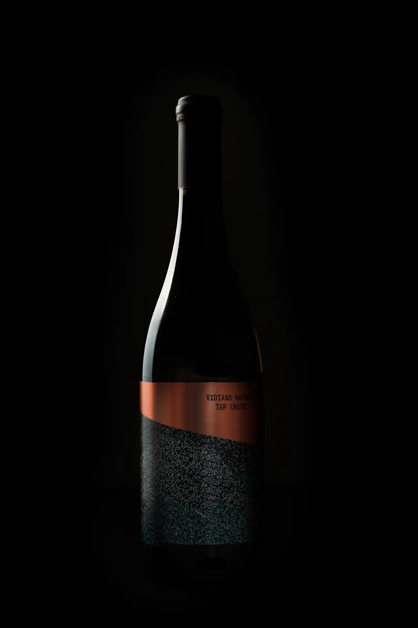 Commercial photoshoot of a wine bottle against a black background
