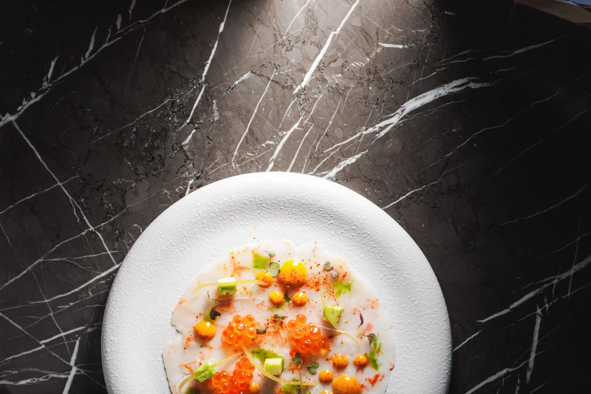 Play of light on a seafood dish at a luxury hotel restaurant in Abu Dhabi