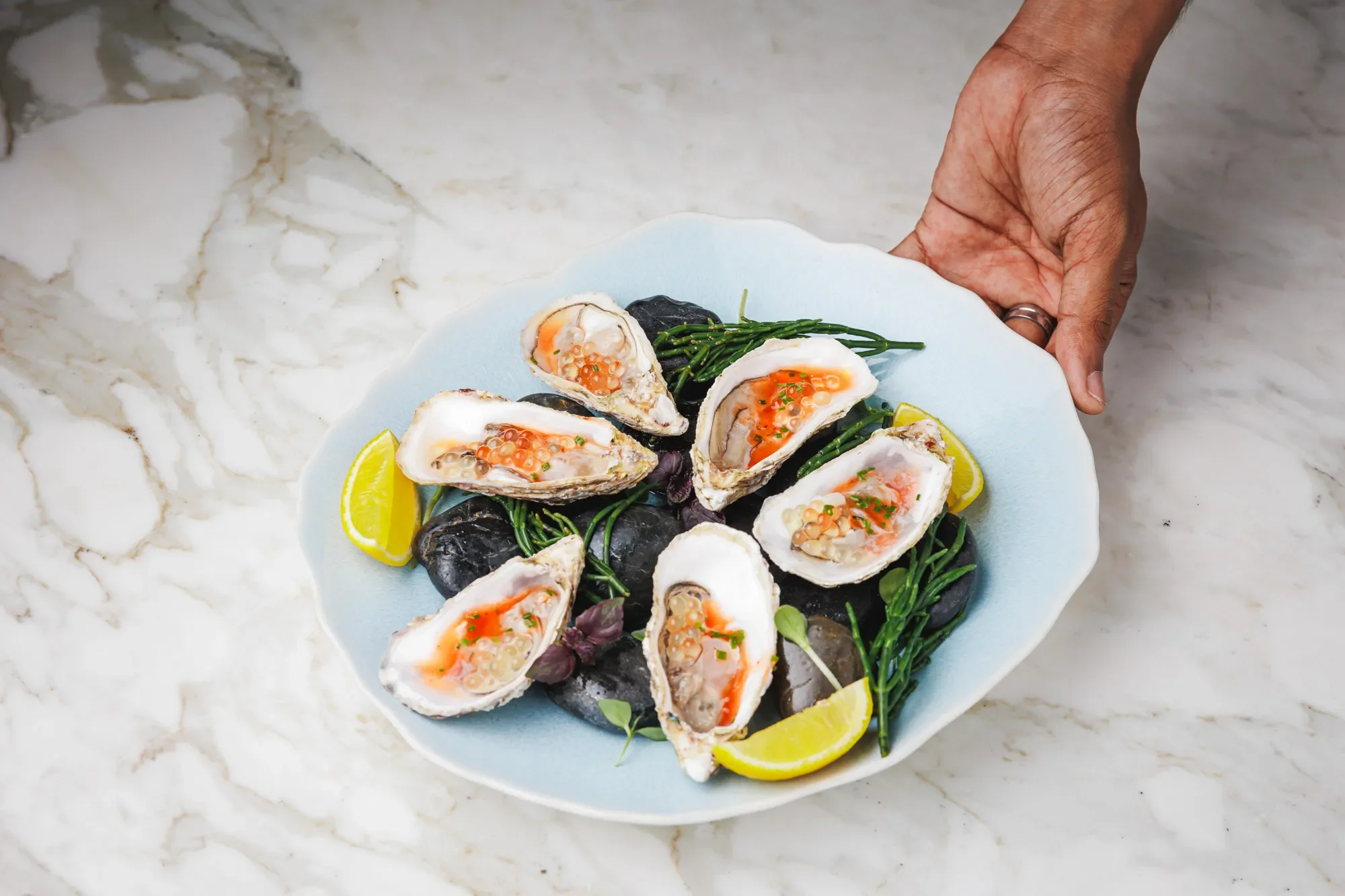 Serving of an oyster dish at a French restaurant in Dubai