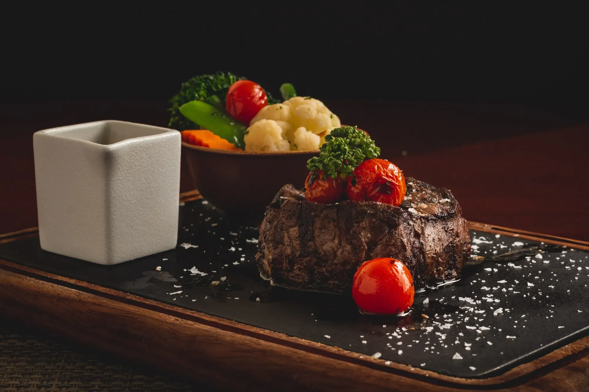 Presentation of a fillet steak on a cutting board and stone surface at a pub in Abu Dhabi