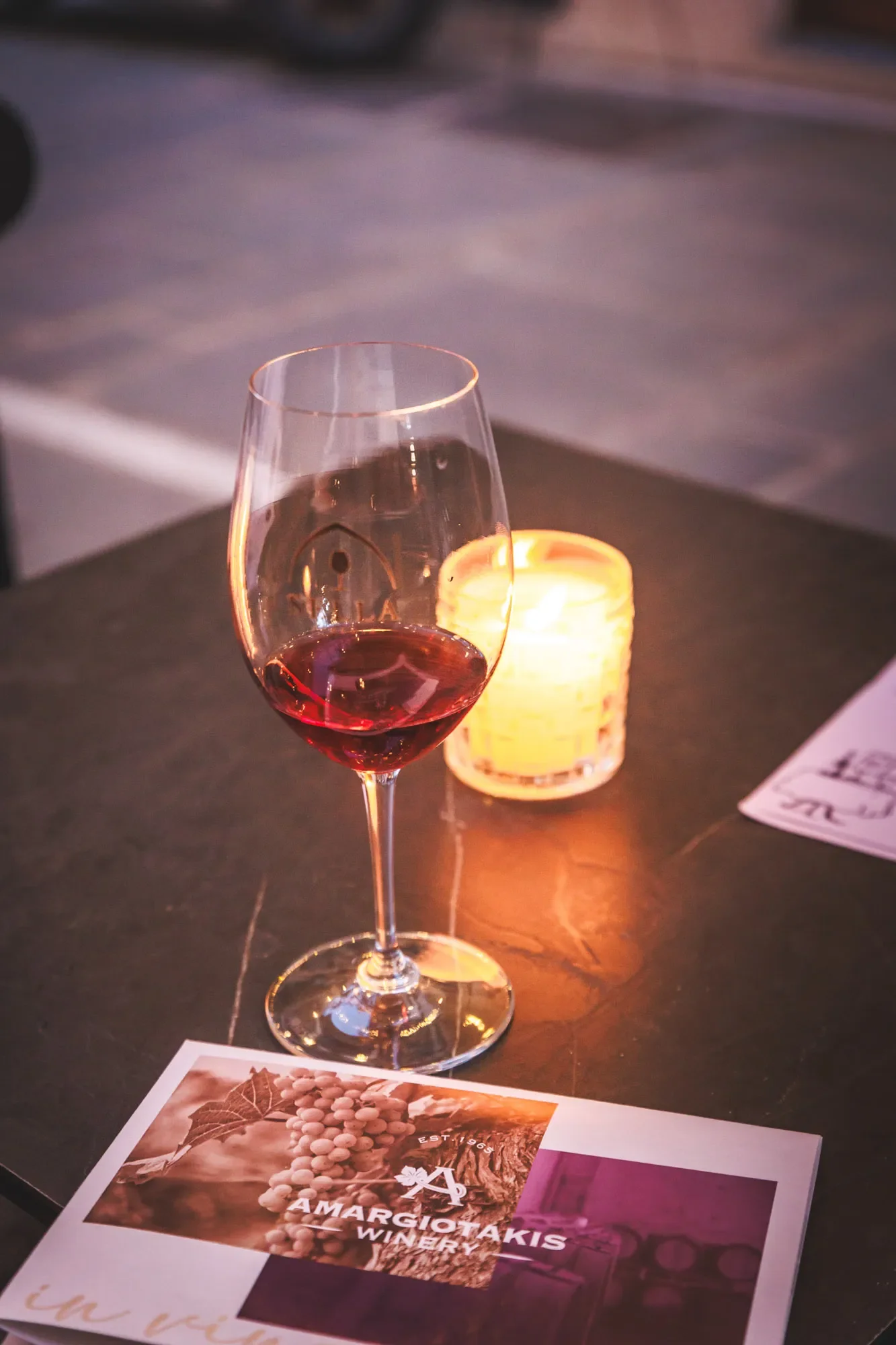 Glass of rosé wine on a wine bar table in Rethymno