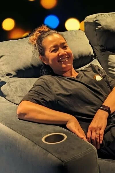 Lady resting in home cinema re4cliner seat with cinema at home shirt