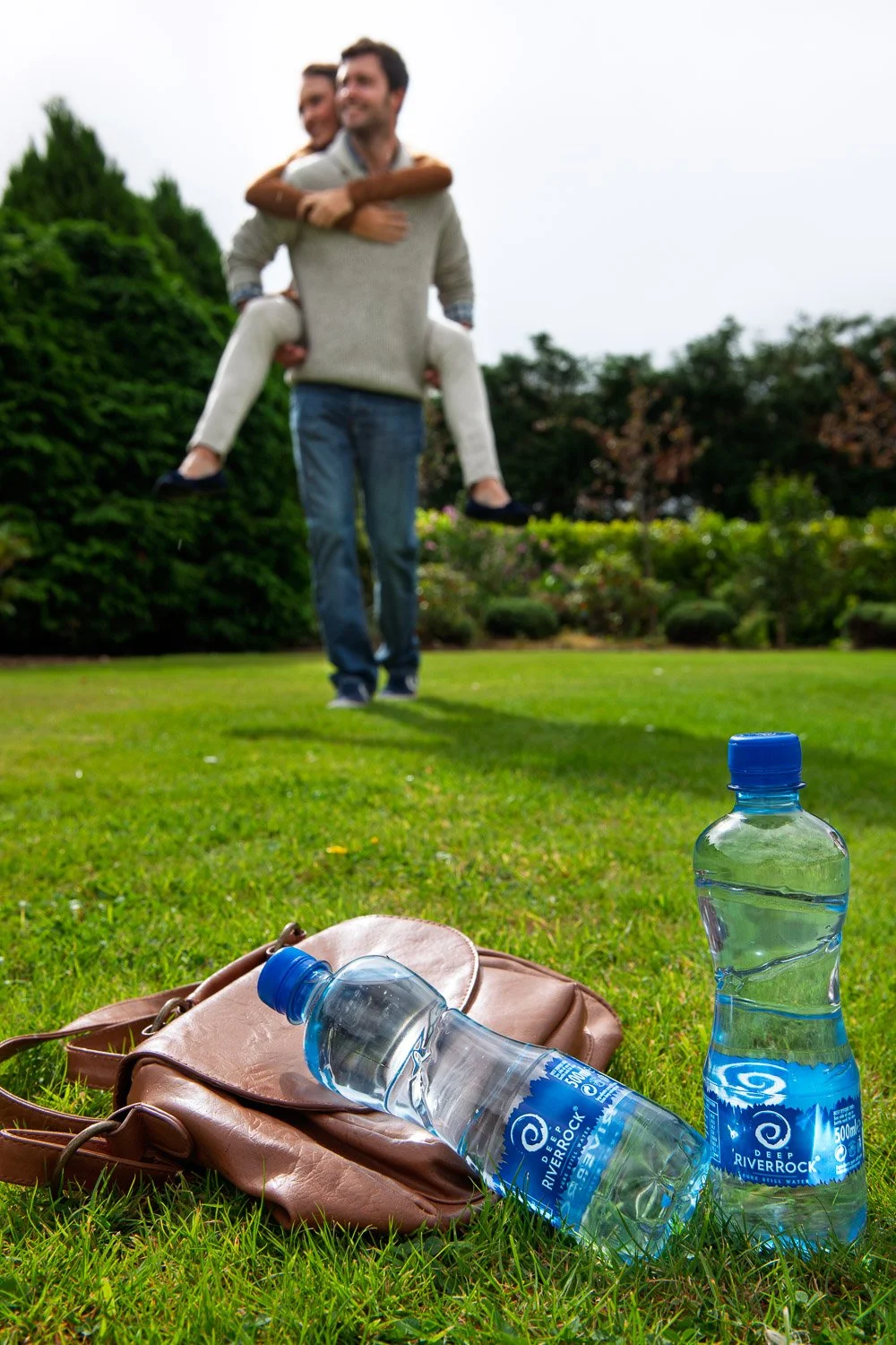 A photograph of a couple in the park during a lifestyle commercial photography shoot for Coca-Cola.