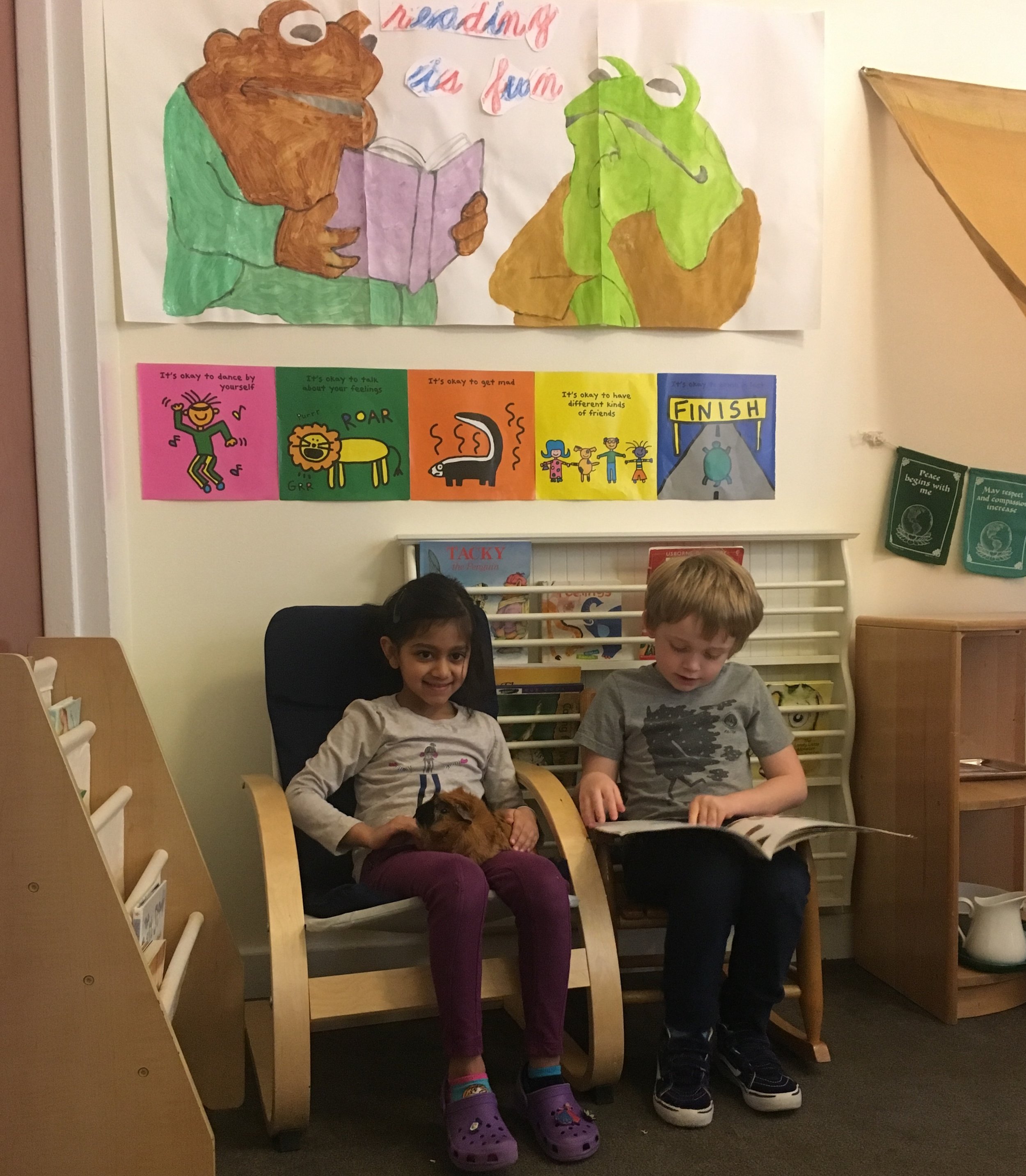 Two friends enjoy a peaceful moment in the library, reading Inch by Inch to Blaise the Guinea Pig