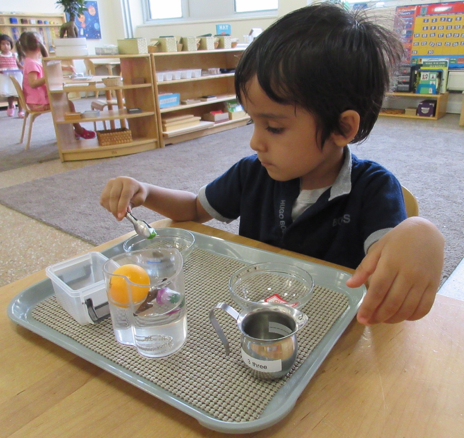 Child experimenting sink and float activity