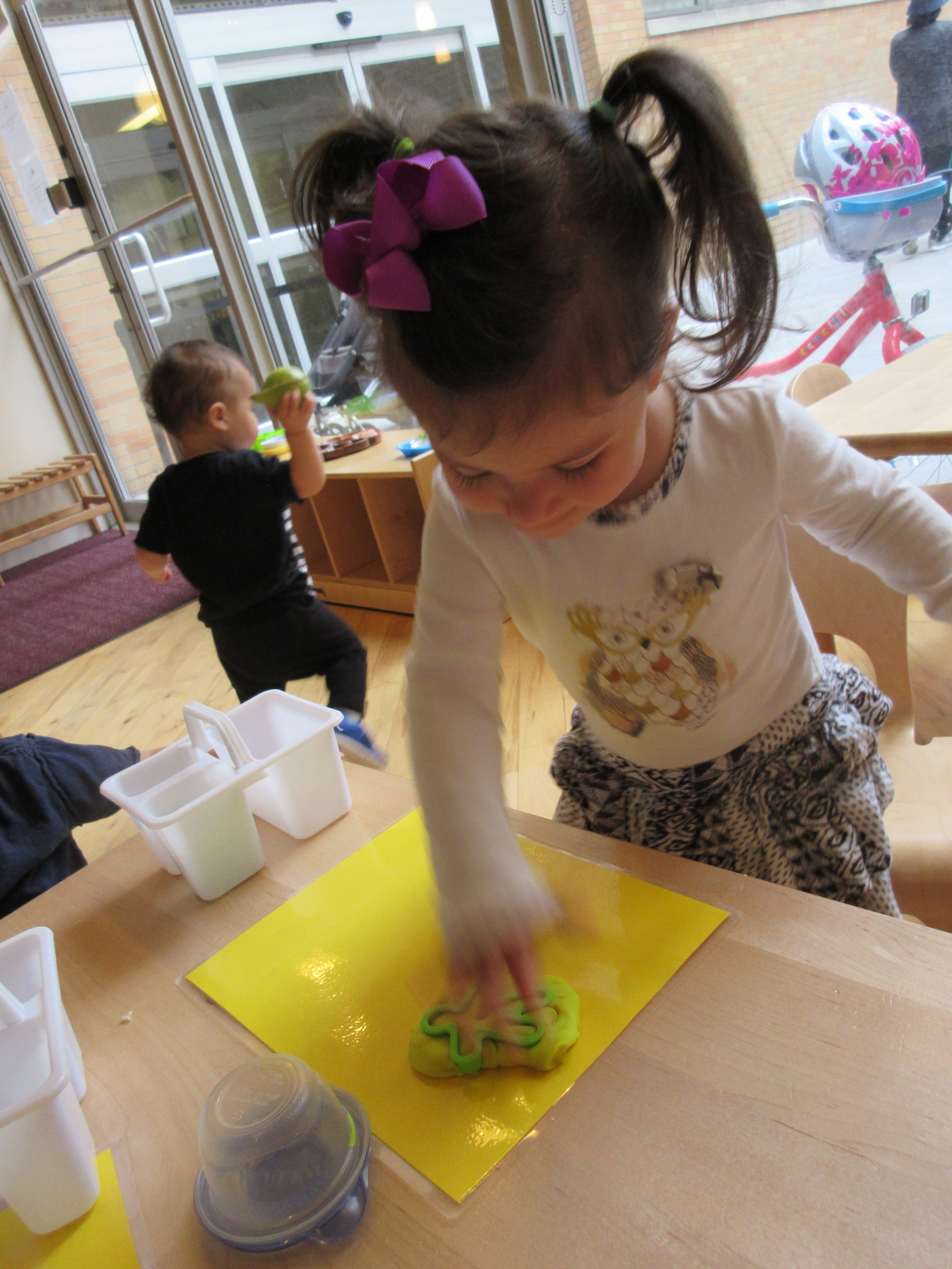 Pressing play doh with a cookie cutter 