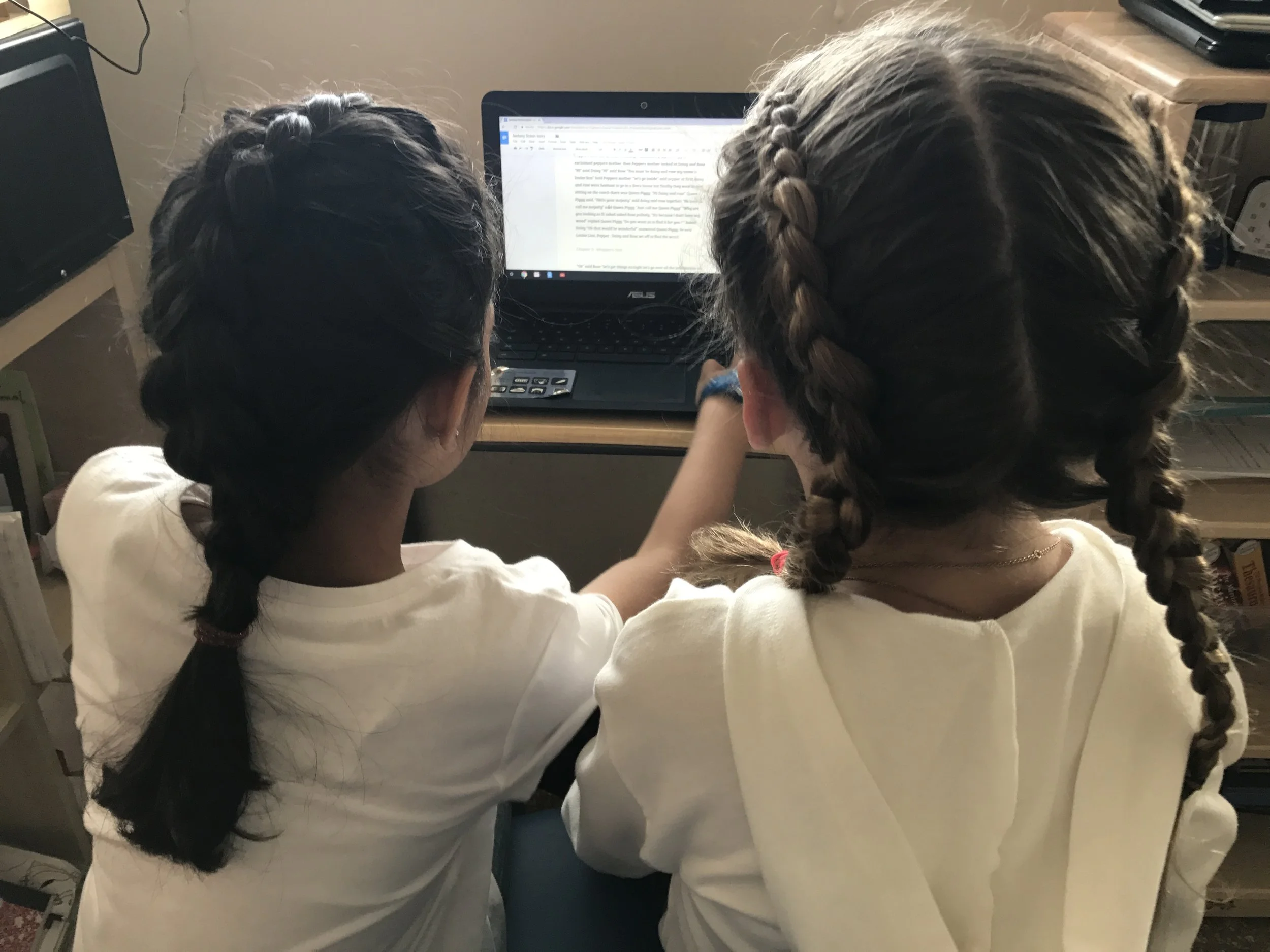 Orion Room friends peer editing their Writer's Workshop pieces 