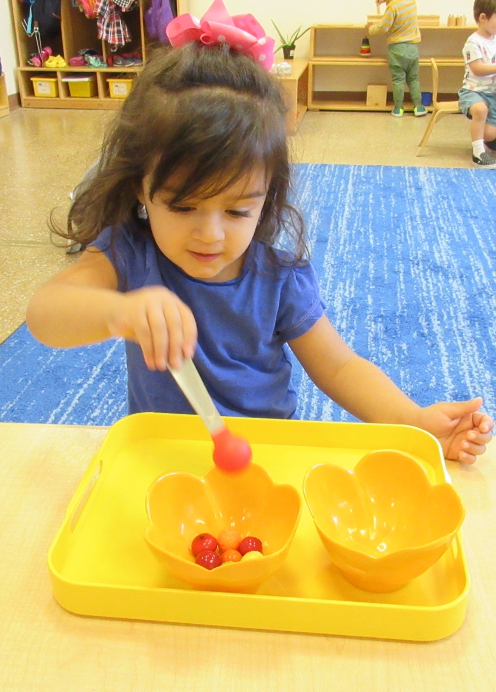 Spoon transfer work helps to build fine motor skills and hand-eye coordination.