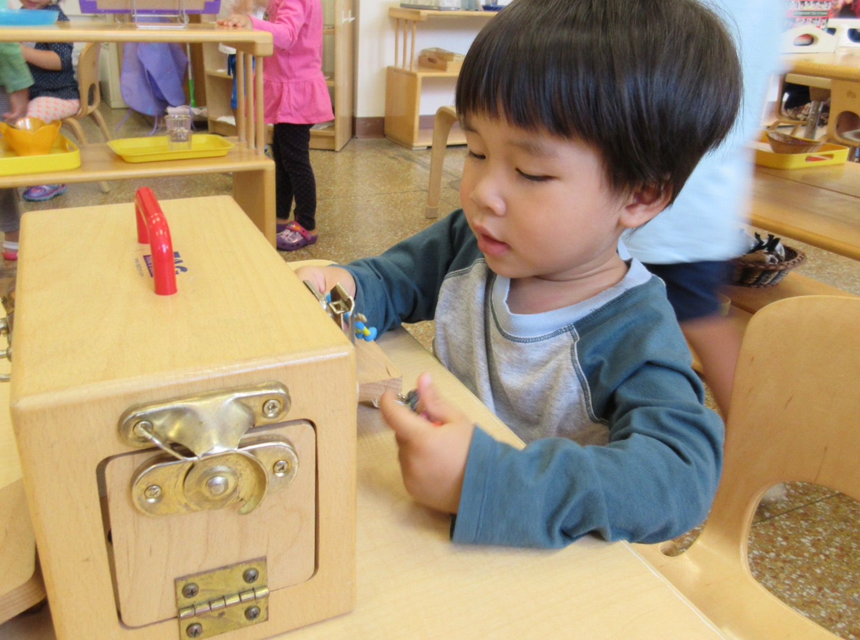 Using fine motor skills to open close the Lock Box